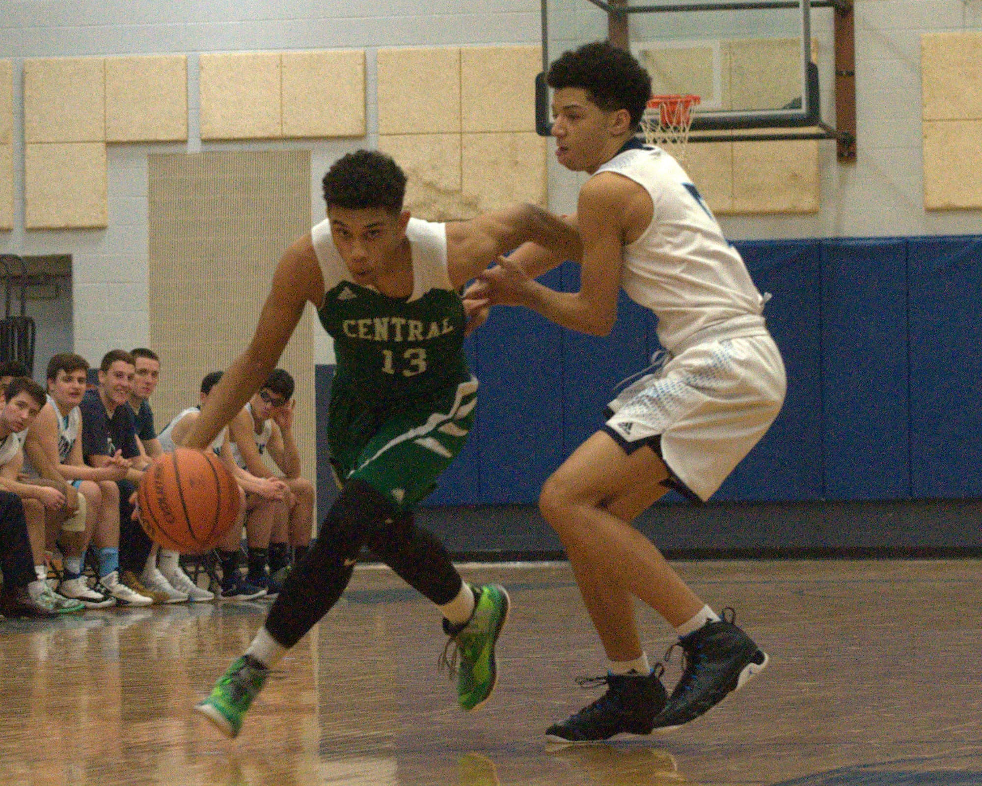 Manchester Central's Jaylen Leroy drives by Nashua North's Alonzo Linton.