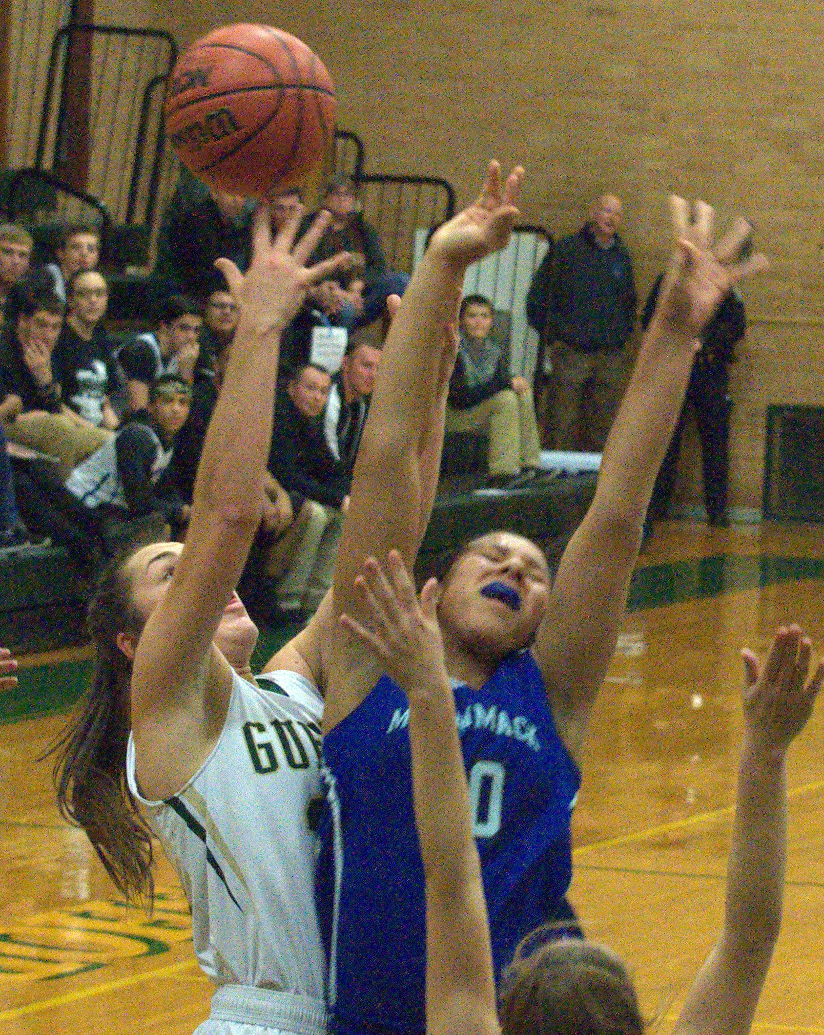 Bishop Guertin's Meghan Cramb and Merrimack's Abby Yuan battle for a rebound.