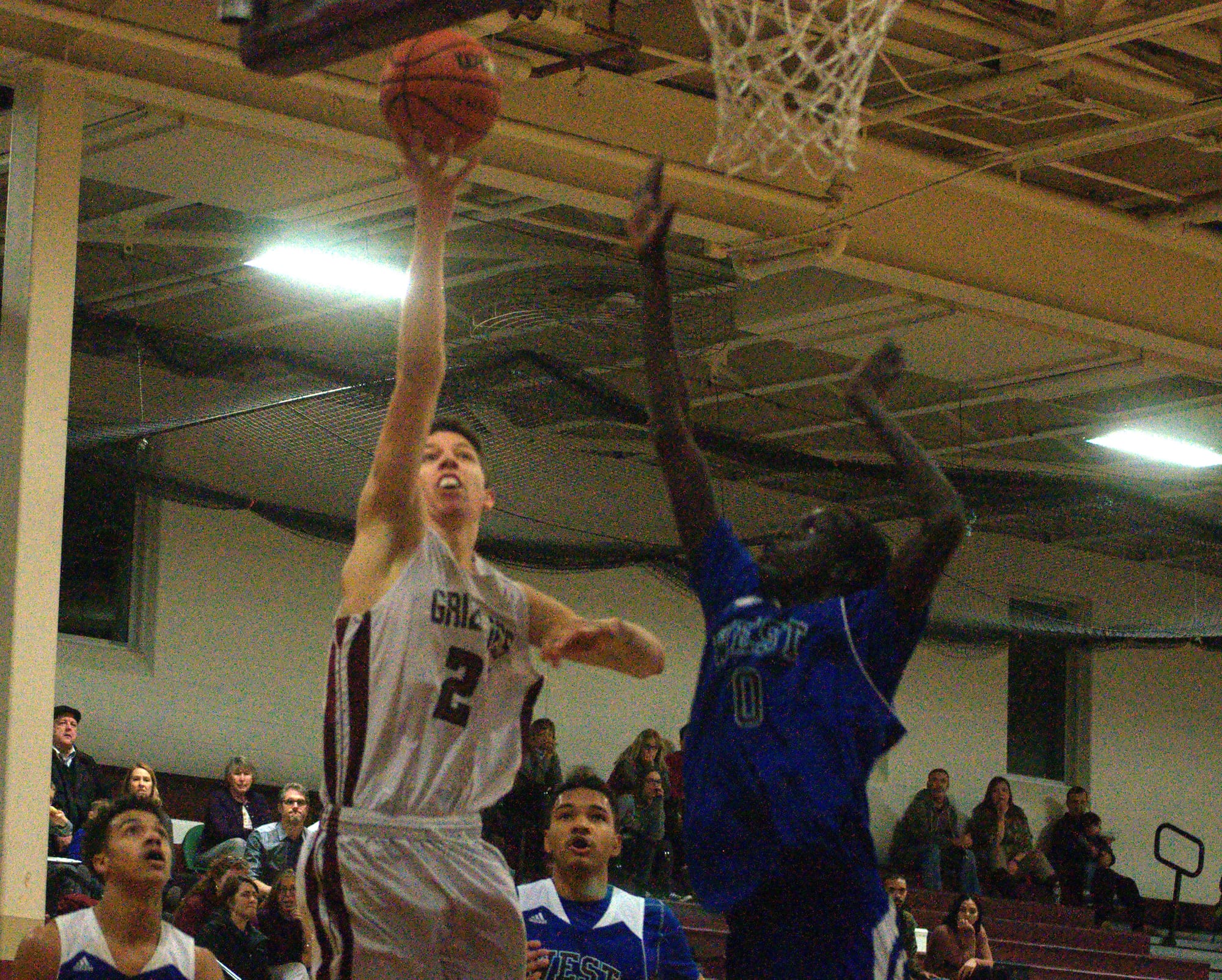 Manchester West's Akok Akok tries to block a shot by Goffstown's Robert Girardin.