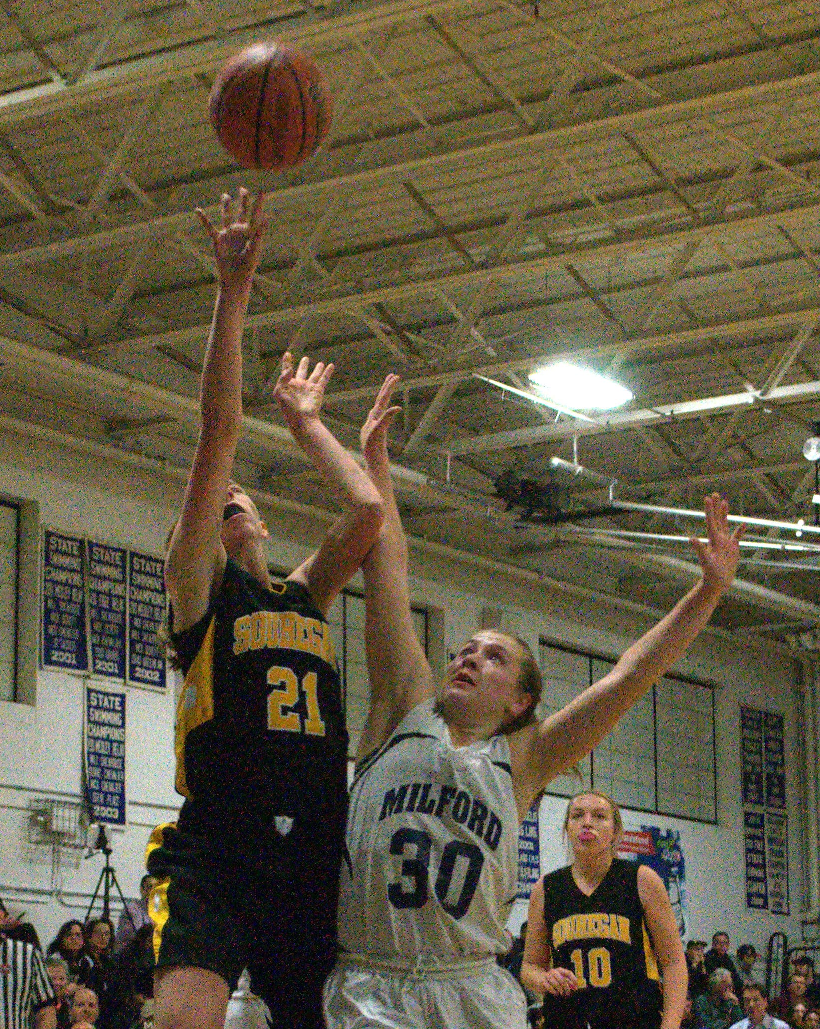 Souhegan's Emma White takes a shot as Milford's Erin McGuire defends.