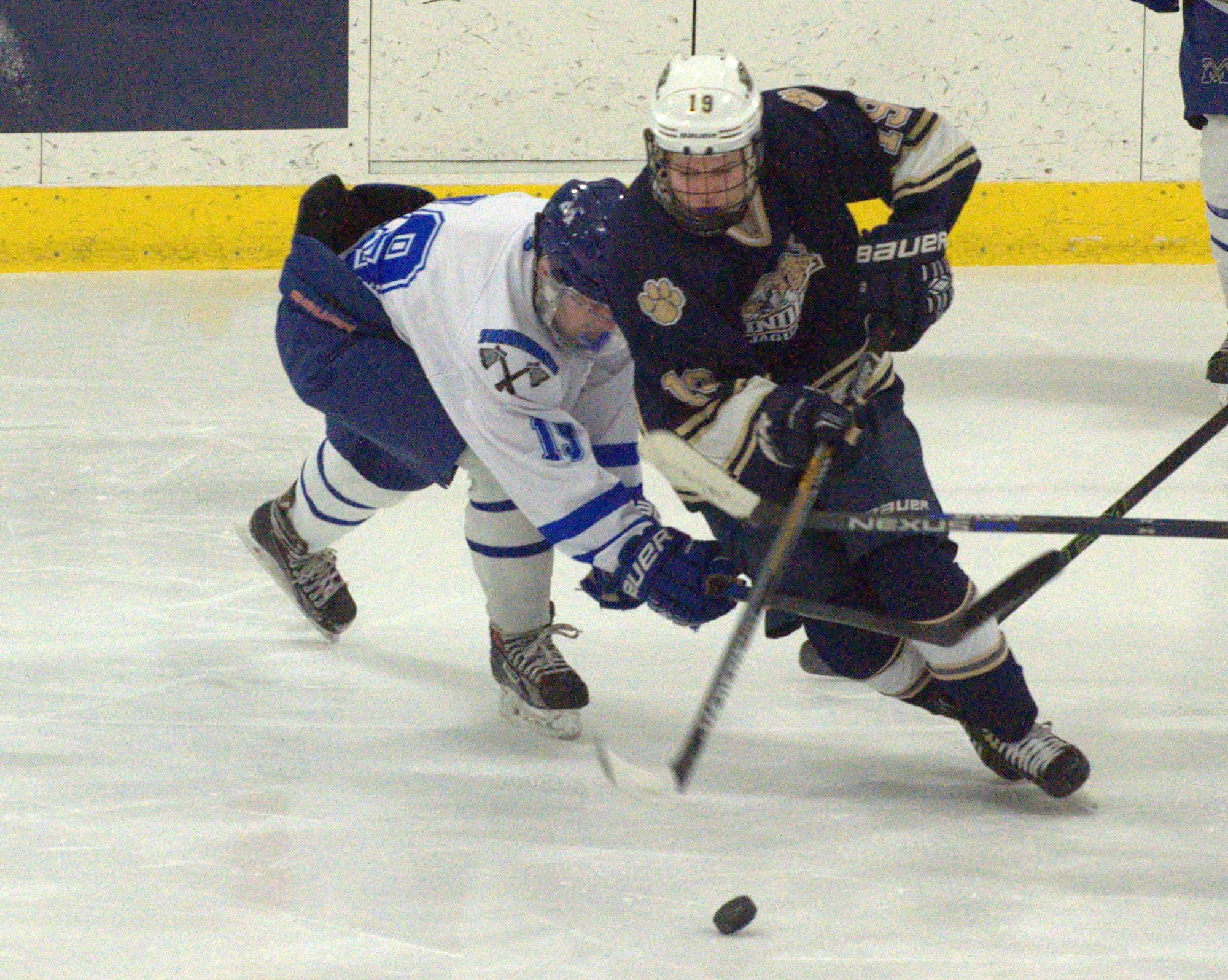Windham's Danny Donovan moves the puck past Merrimack's Stephen Licata.