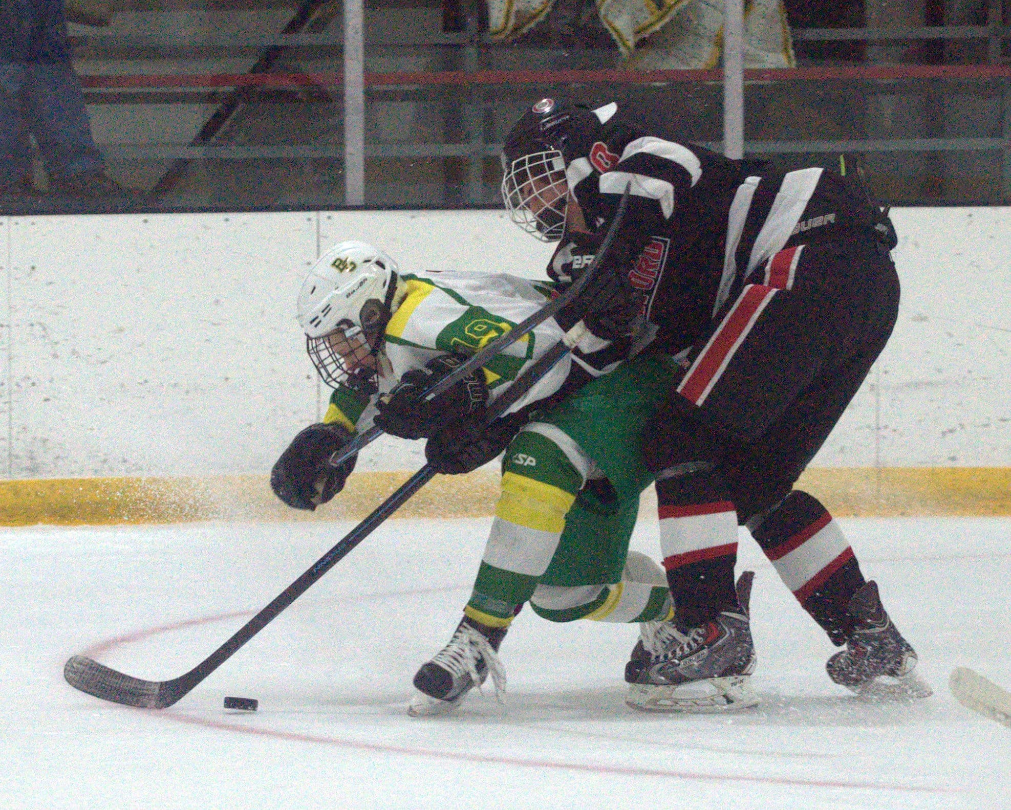 Bishop Guertin's Cameron Fagan gets between the puck and Bedford's Tyler Gamble.