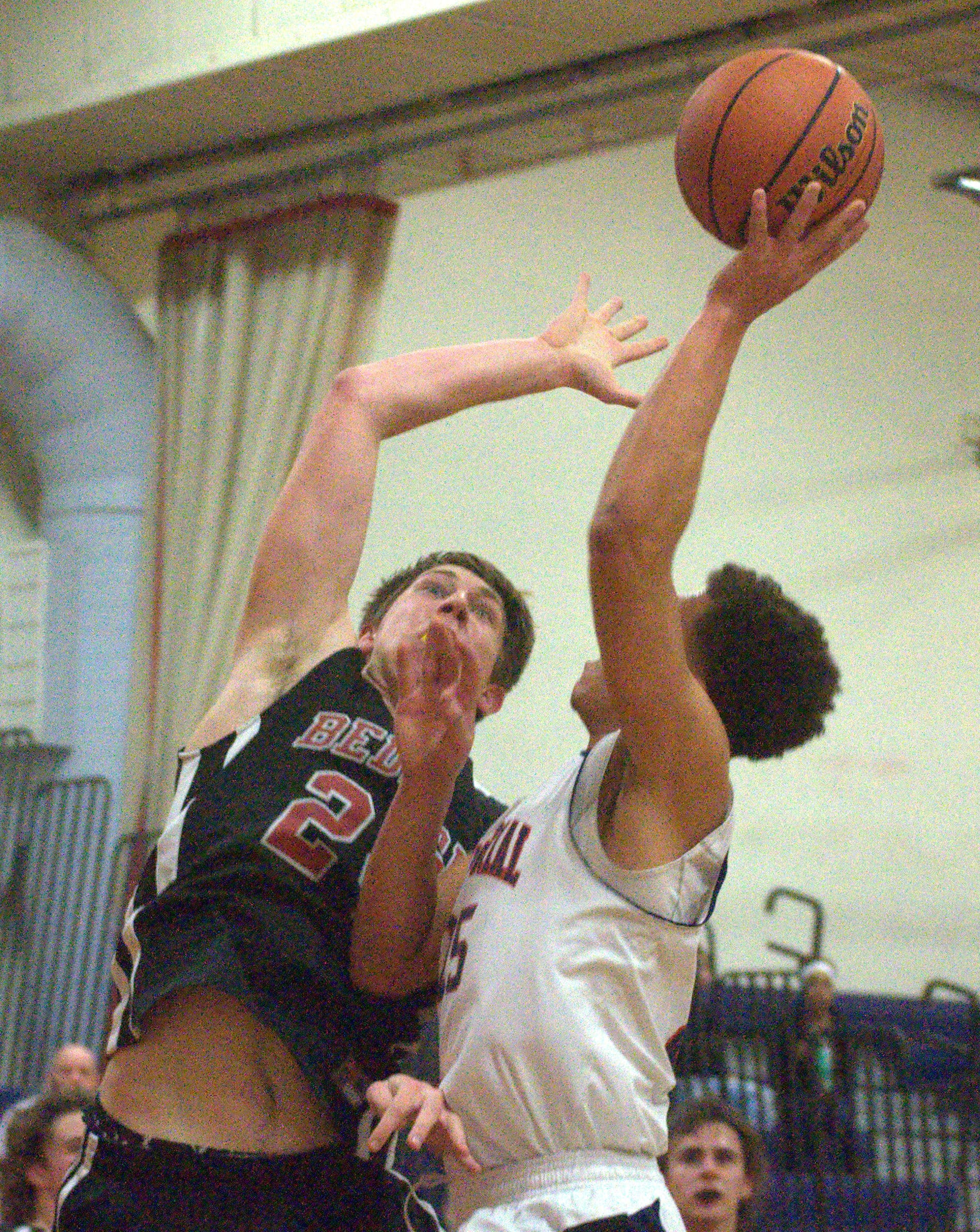 Bedford's Colby Gendron tries to block a shot by Manchester Memorial's Brandon Scott.
