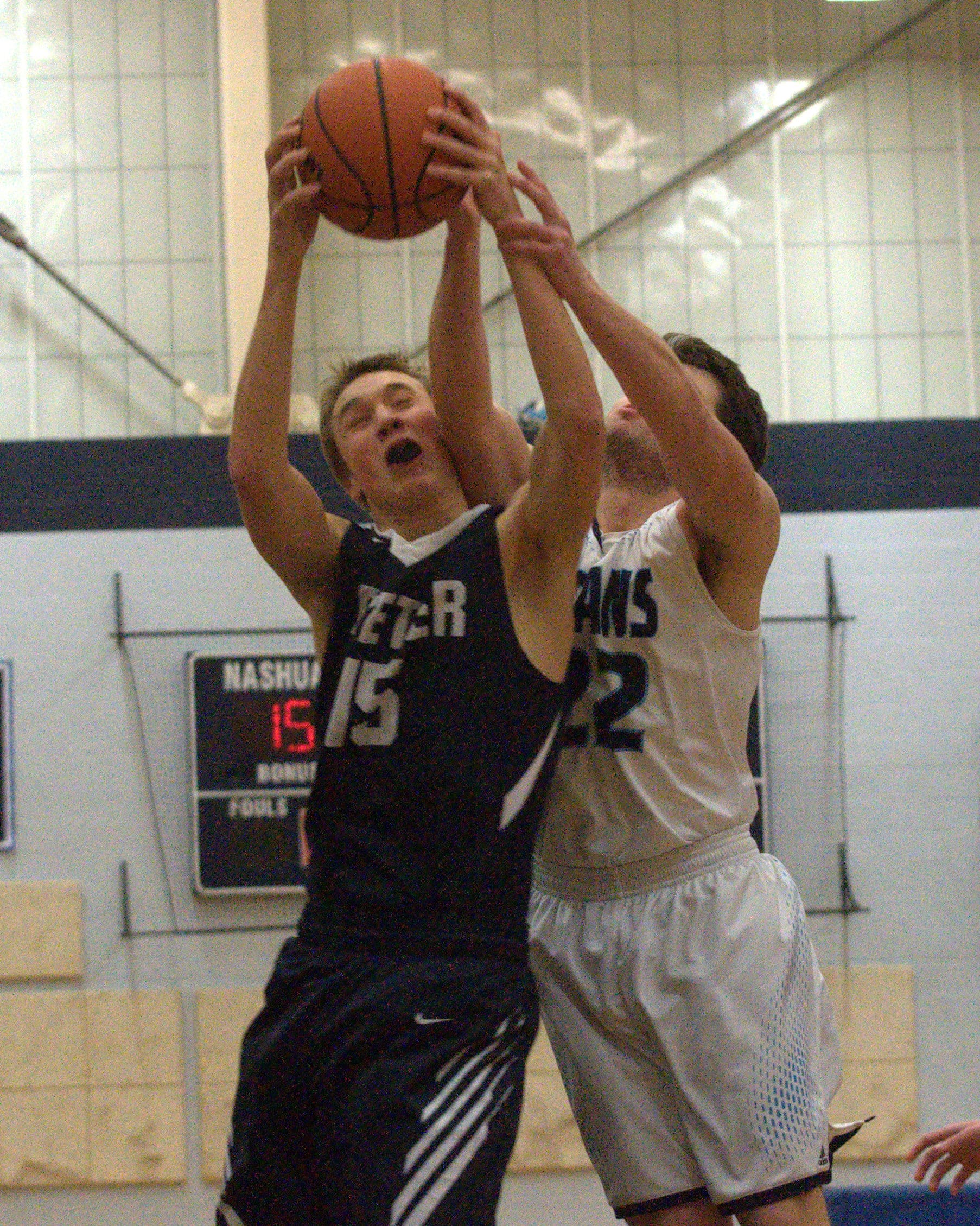 Exeter's Alexander Price and Nashua North's Shane LeGraw battle for a rebound.