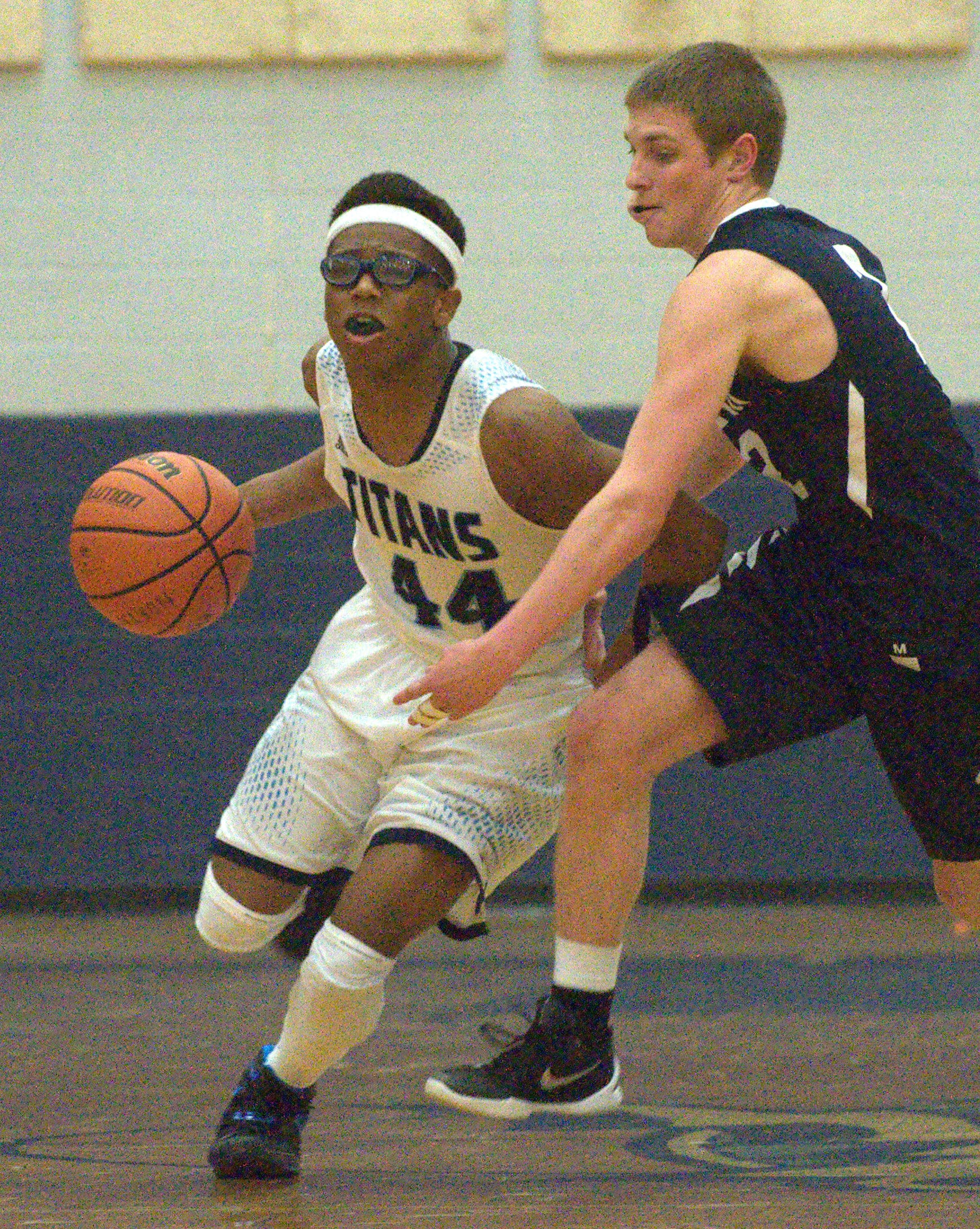 Nashua North's Sclyler Boykin dribbles by Exeter's Nick Sowers.