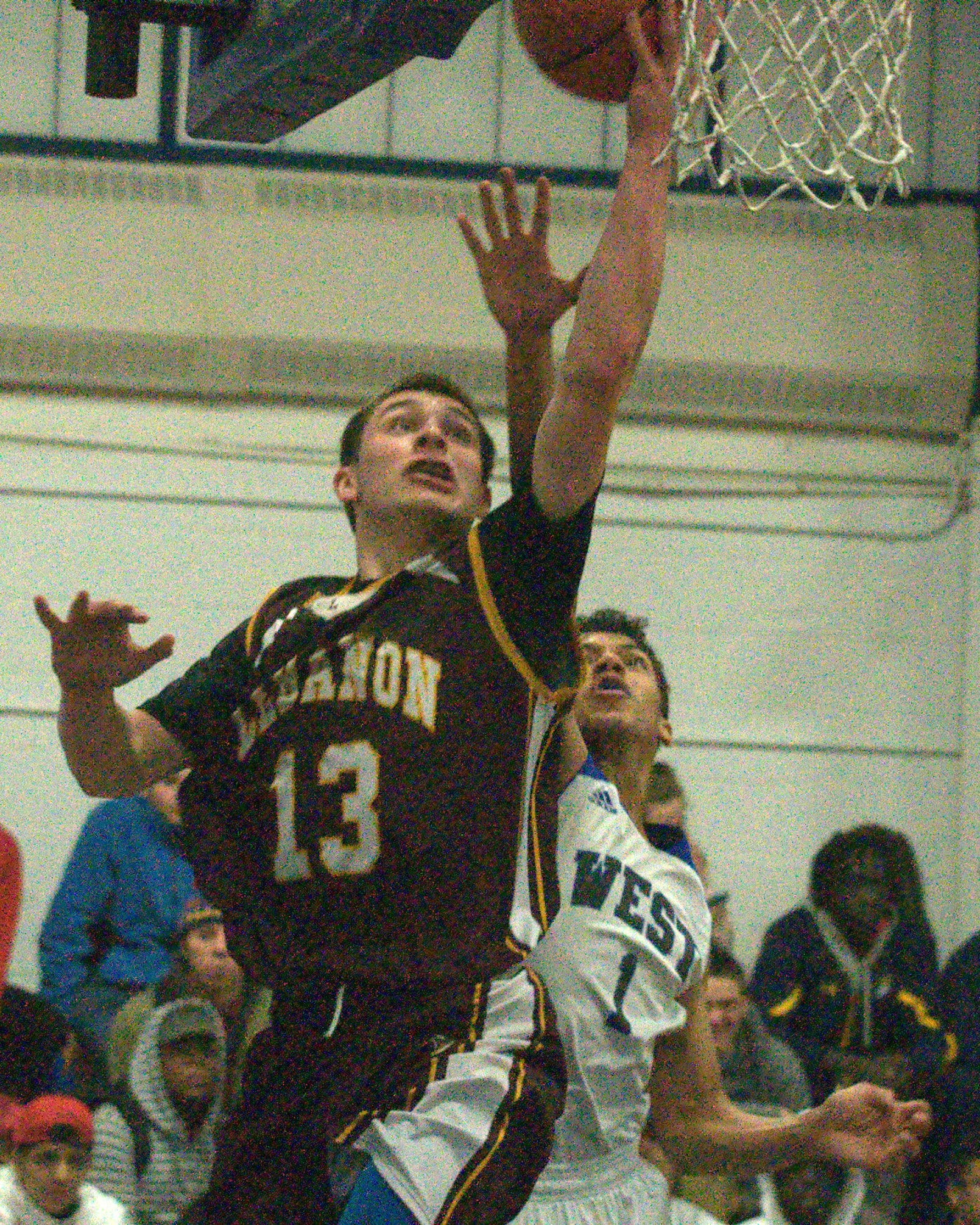 Lebanon's KJ Matte drives to the basket as Manchester West's Jacobee Burpee defends.
