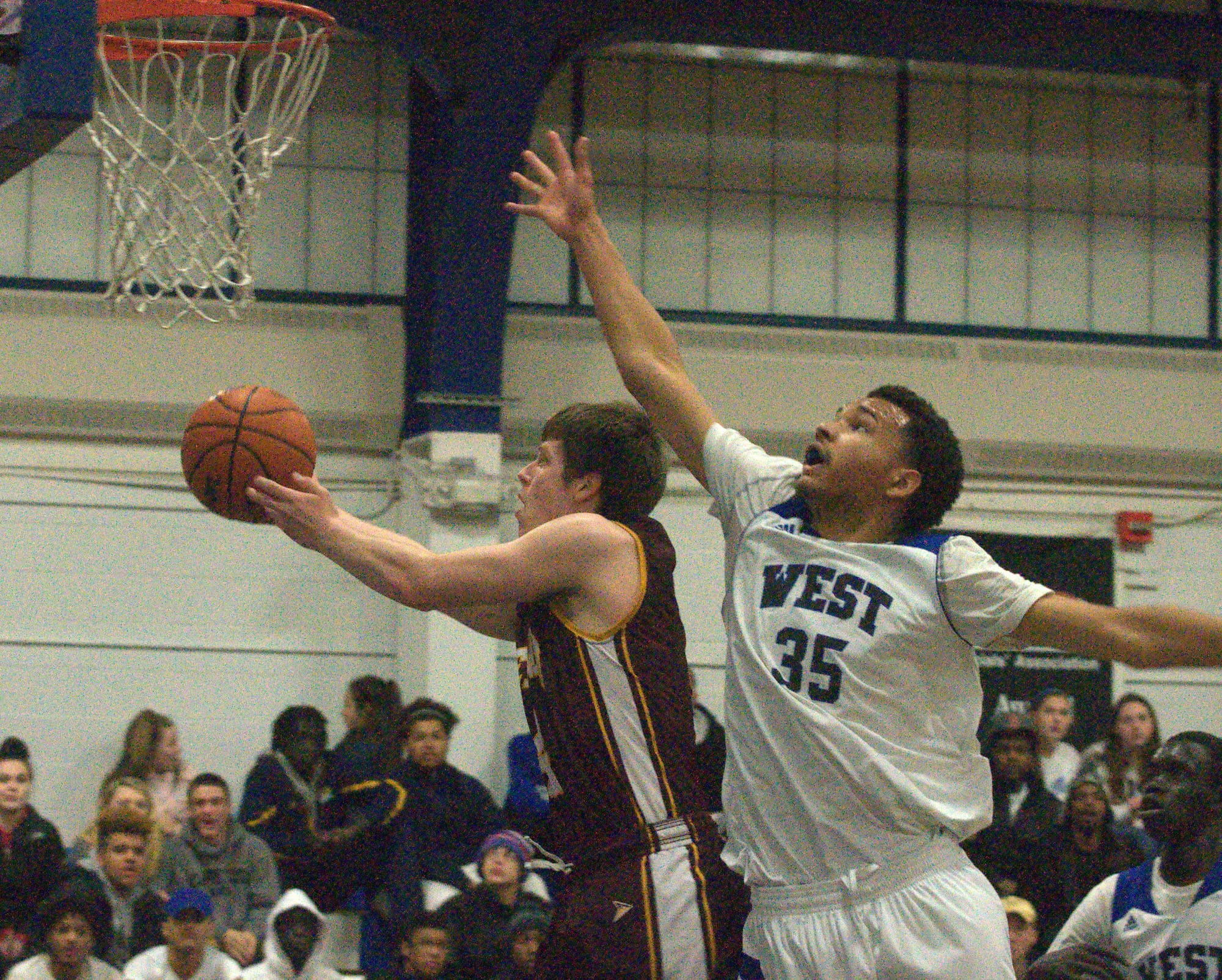 Manchester West's Keenan Caron tries to block a shot by Lebanon's Jake Hansen.
