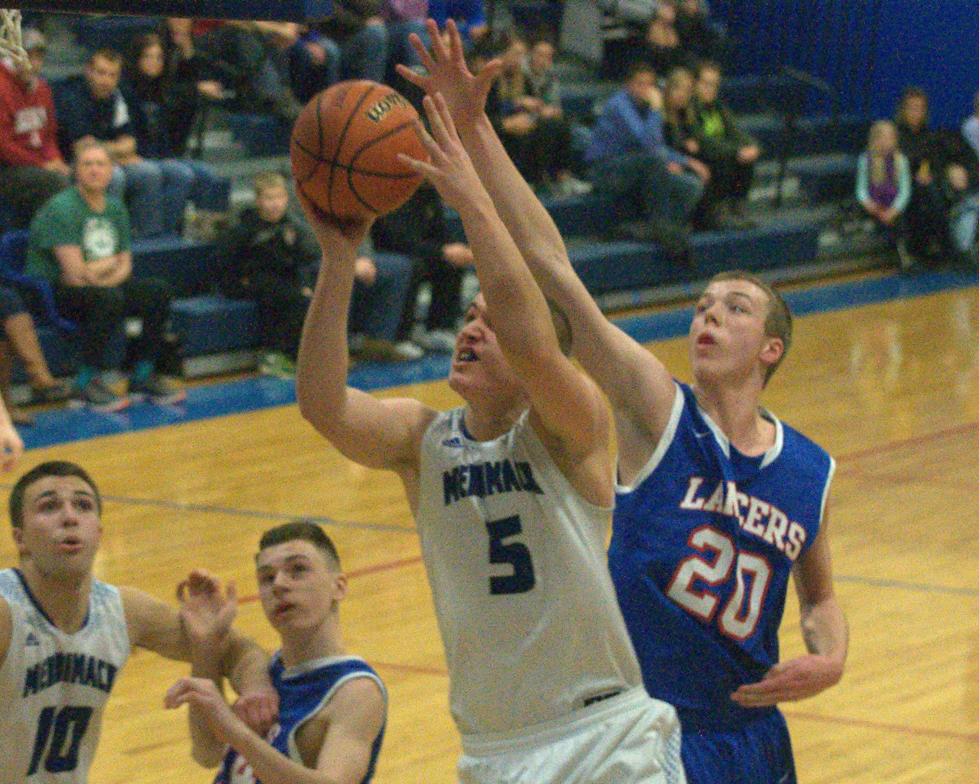 Merrimack's Ian Roberts drives to the basket as Londonderry's Matt Corey defends.