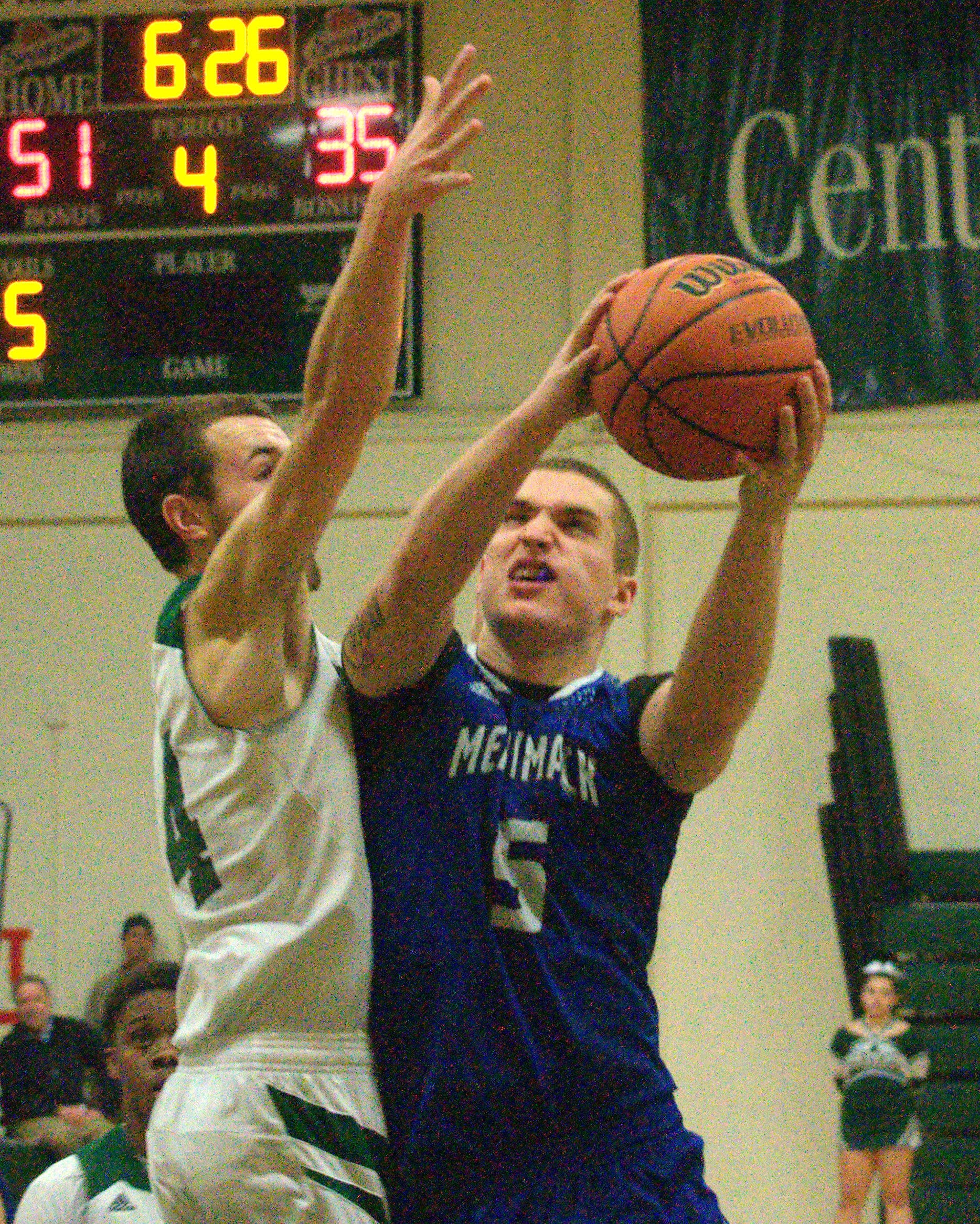 Merrimack's Ian Roberts drives to the basket as Manchester Central's Evan MacDonald defends.
