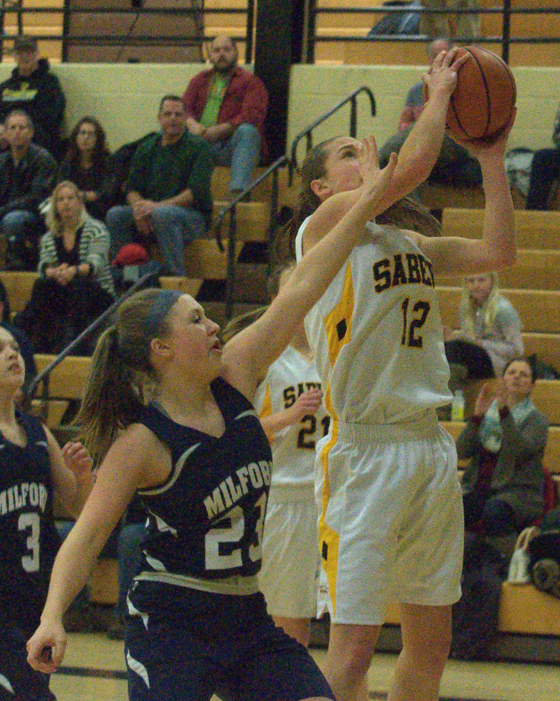 Souhegan's Hannah Chick takes a shot as Milford's Christina Arnoldy defends.