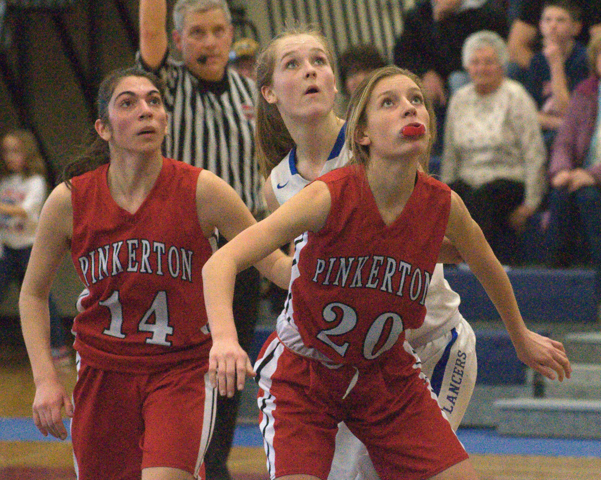 Pinkerton's Courtney Velho, right, and Victoria Overko wait for a rebound with Londonderry's Ashley Evans.