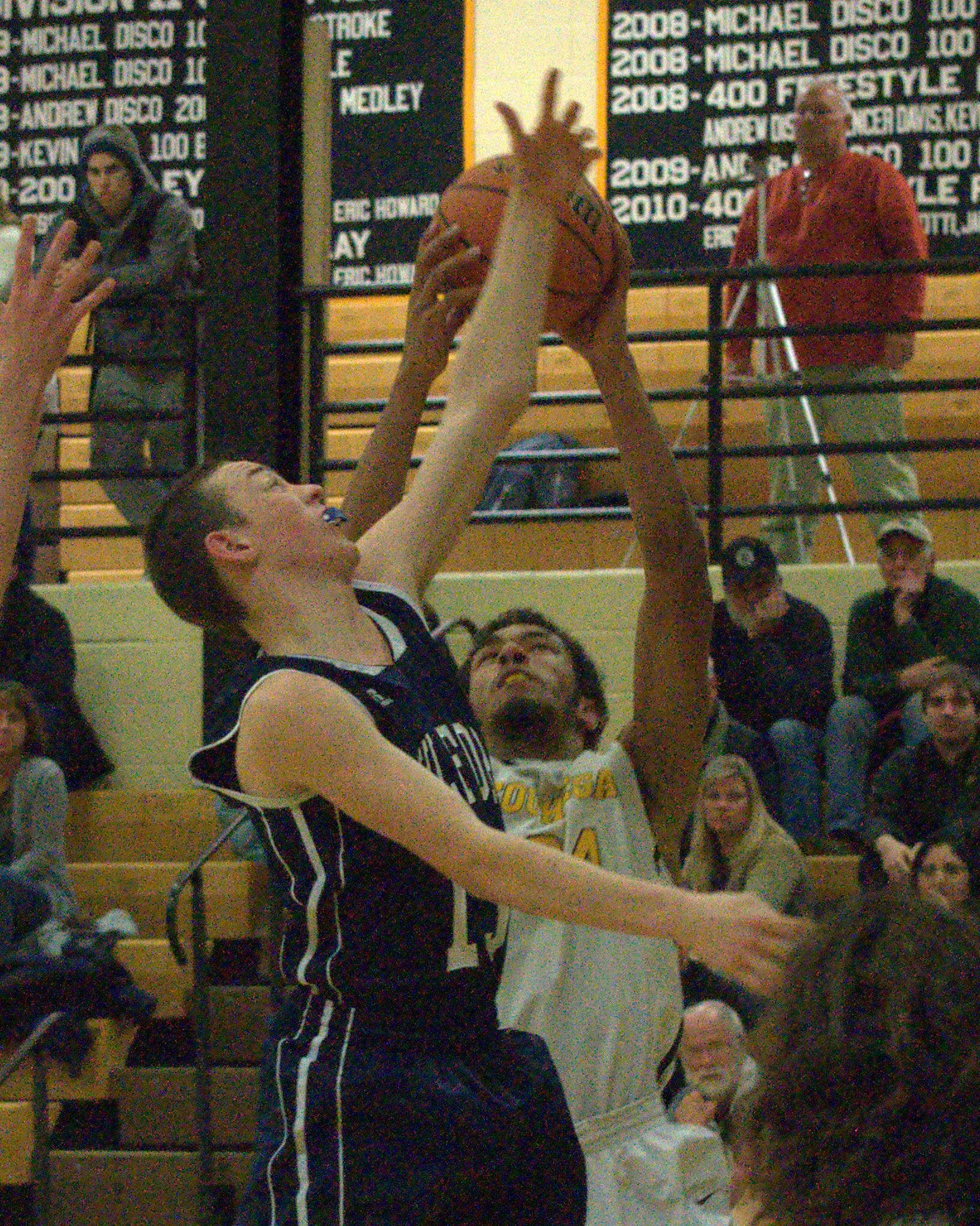 Souhegan's Jerrell Webster grabs a rebound from Milford's Ryan Banuskevich.