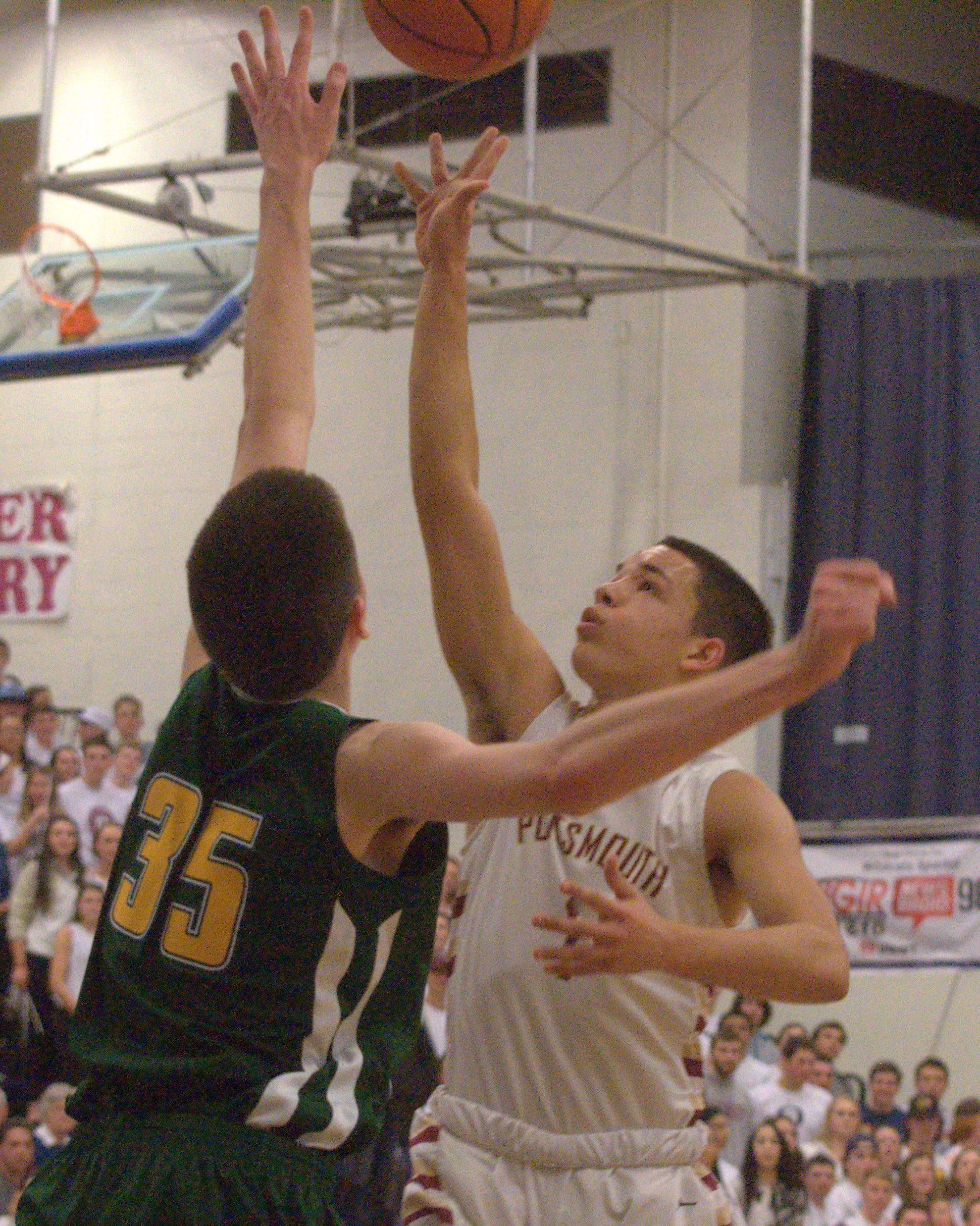 Portsmouth's Shon Parham puts up a shot as Bishop Brady's Matt Desmarais defends.