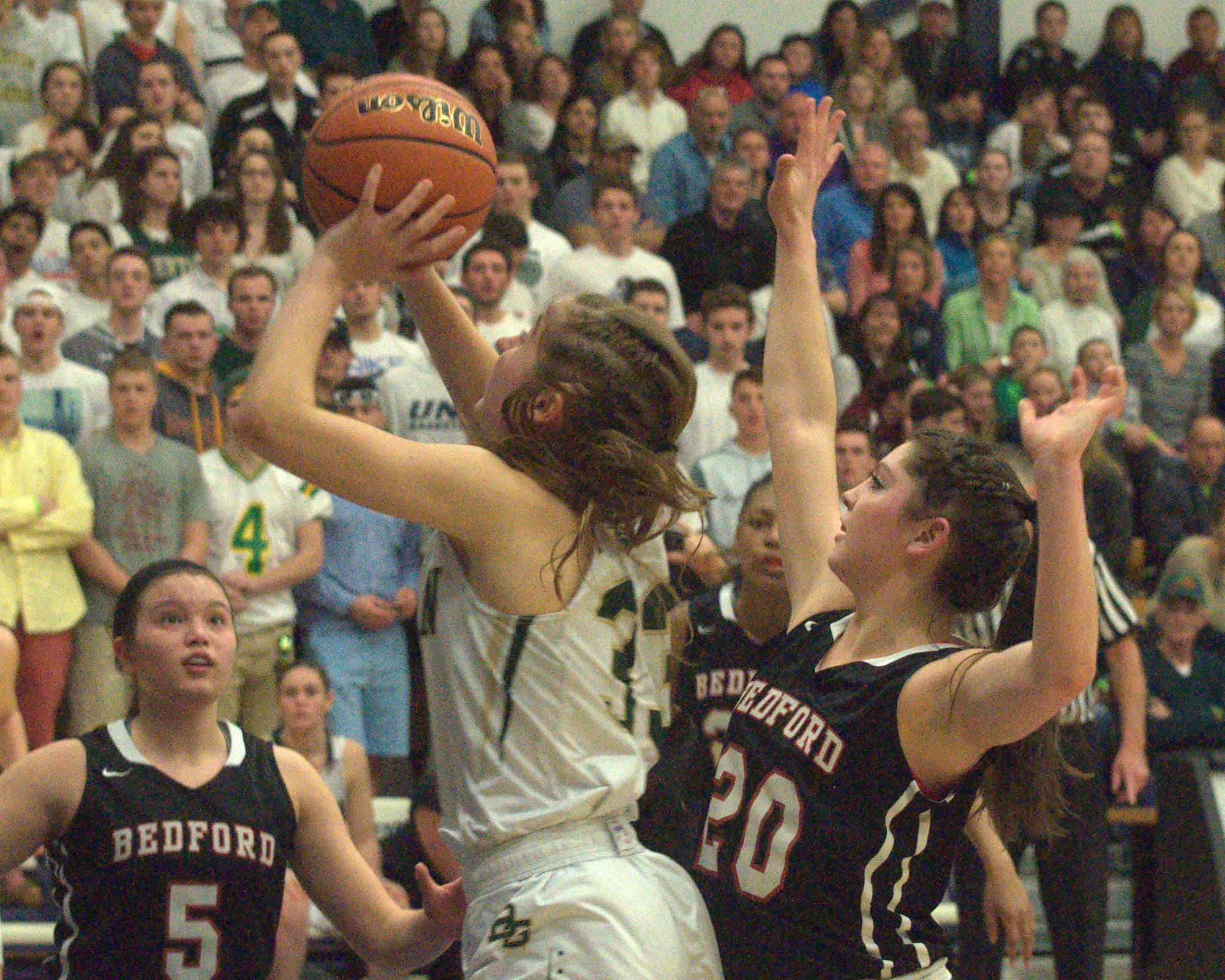 Bishop Guertin's Meghan Donovan goes to the basket as Bedford's Nikki Tucci defends.