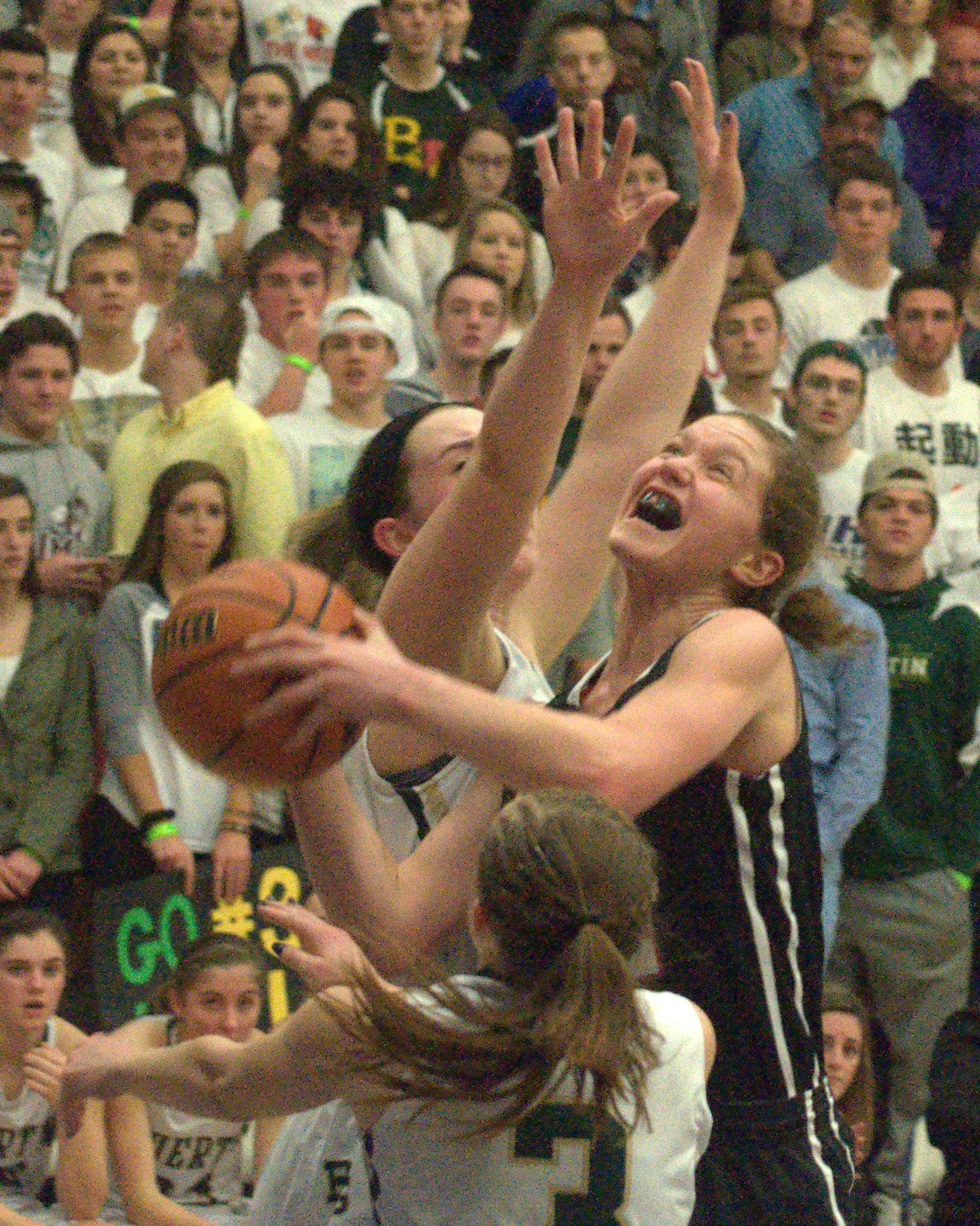 Bedford's Madeline Blake drives to the basket as Bishop Guertin's Marie Laplante, front, and Abbi Field defend.