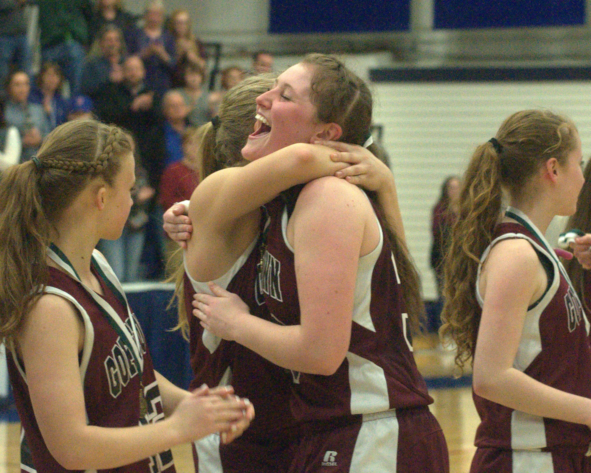 Goffstown's Kathryn Howe gets a hug from a teammate after Friday's win over Hanover.