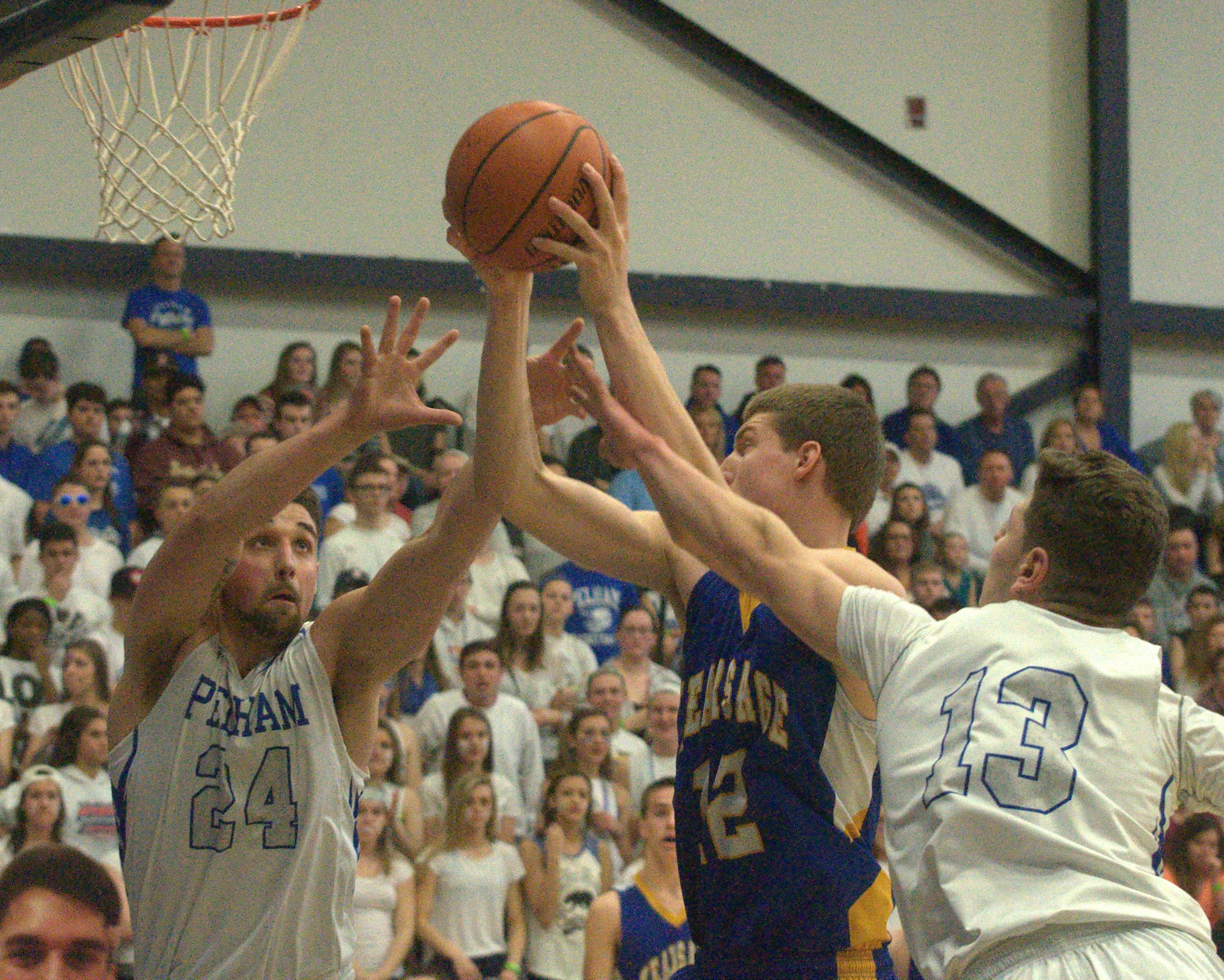 Pelham's Keith Brown, left, and Joe Pantaleo battle for a rebound with Kearsarge's Zachary Mattos.