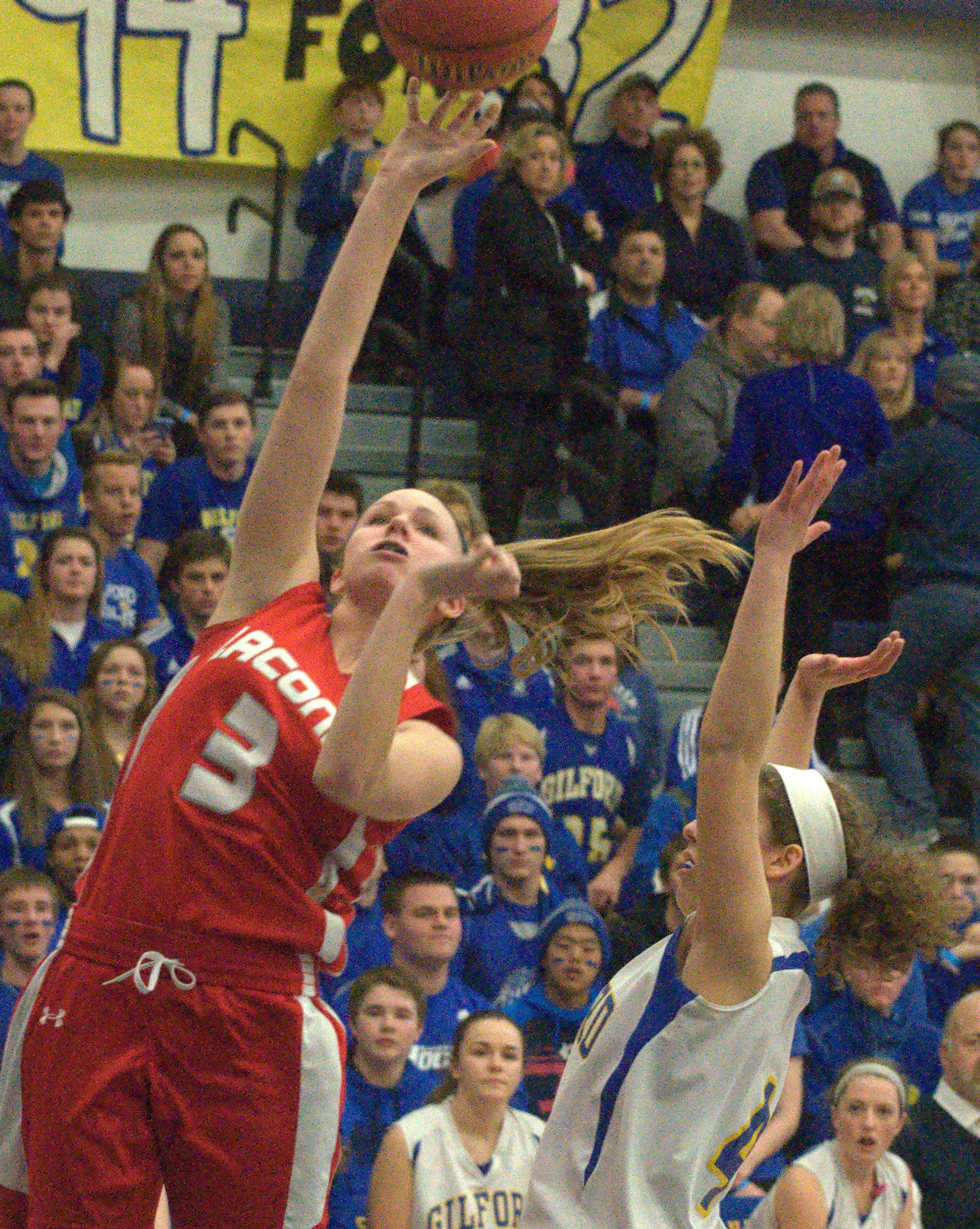 Laconia's Helen Tautkus takes a shot over Gilford's Brooke Beaudet.