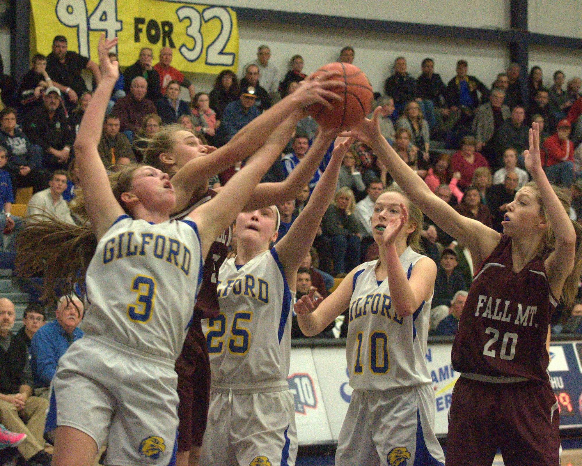 Gilford and Fall Mountain players battle for a rebound.