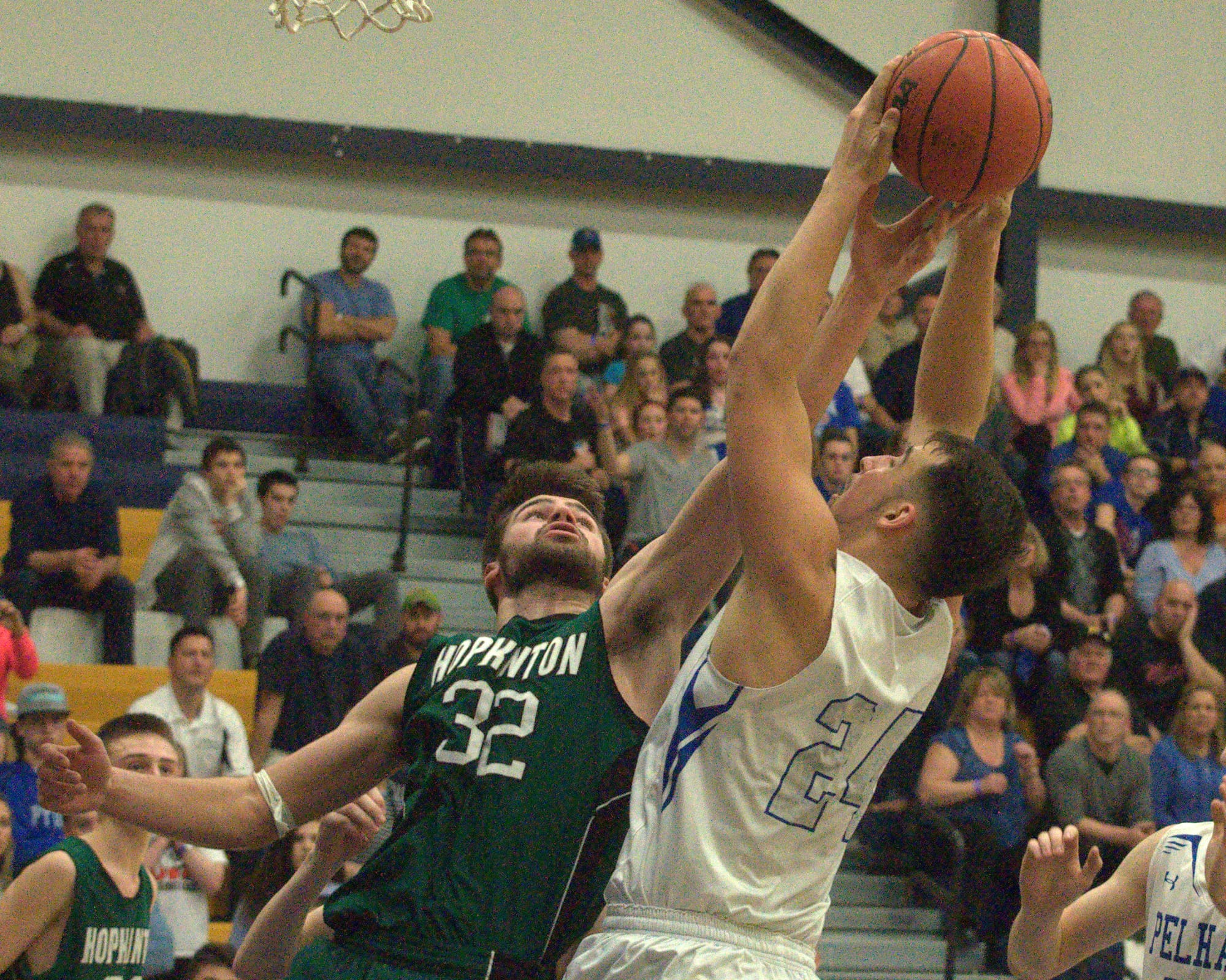 Hopkinton's Nick Meserv tries to block a shot by Pelham's Keith Brown.