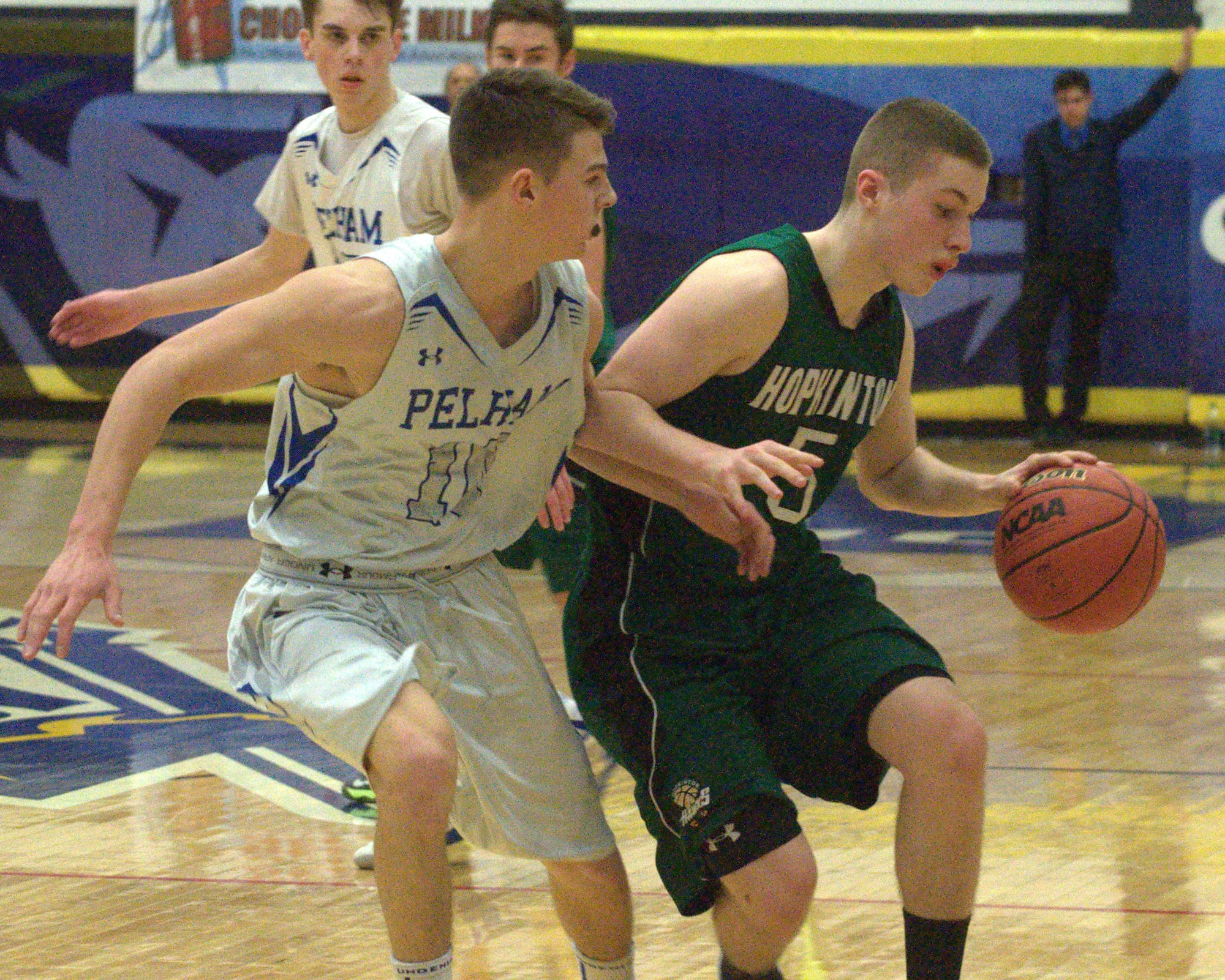 Pelham's Trevor Gagnon defends as Hopkinton's Cam Cyr brings the ball down the floor.