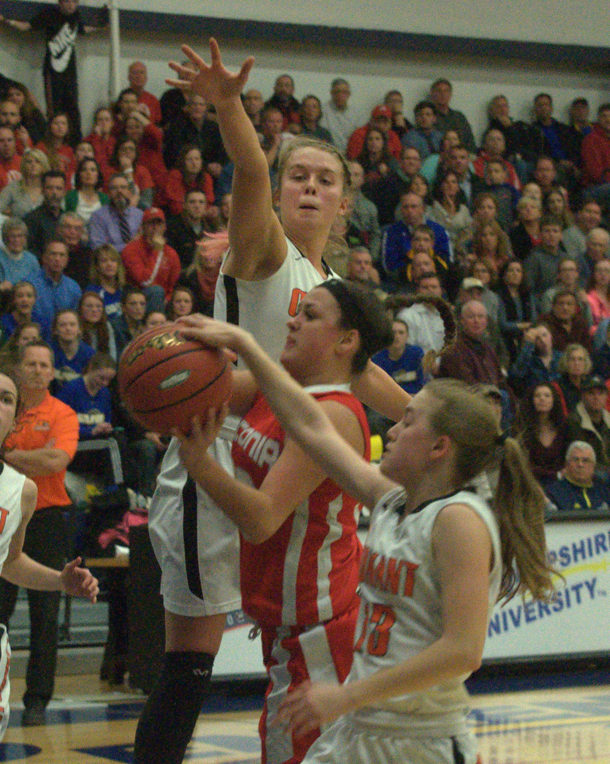 Conant's Madison Springfield, top, and Taylor Banish try to block a shot by Laconia's Erika Marchione.