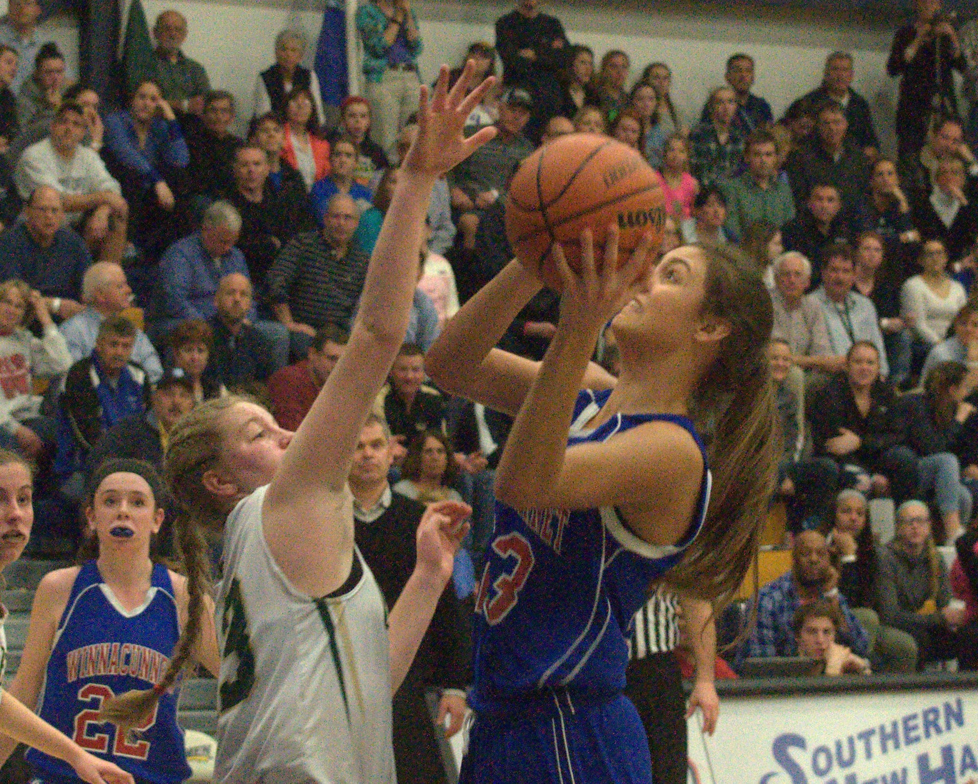 Winnacunnet's Kaya Cadagan takes a shot as Bishop Guertin's Rachel Marion defends.