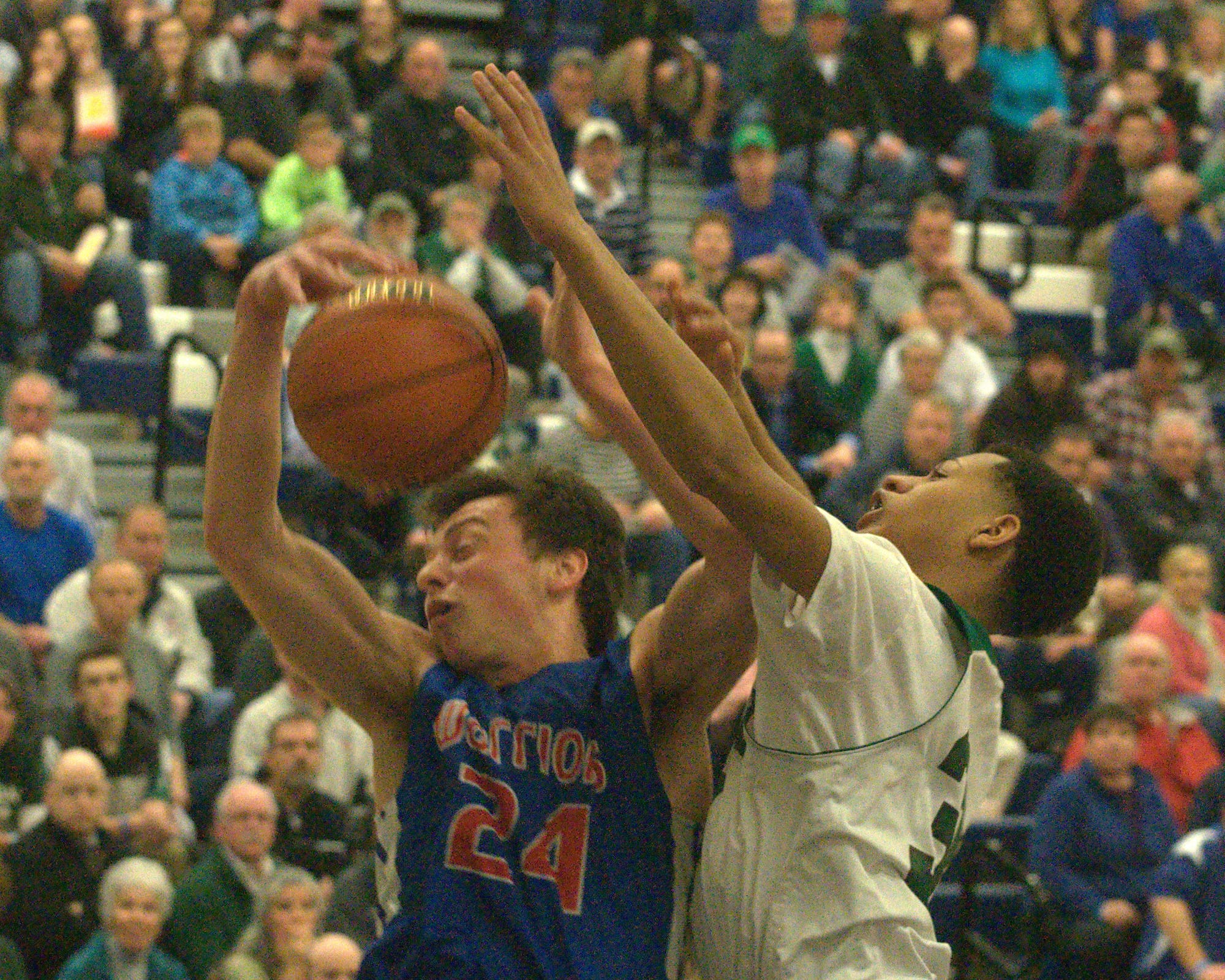 Winnacunnet's Freddy Schaake and Manchester Central's Osiah Lewis go for a rebound.