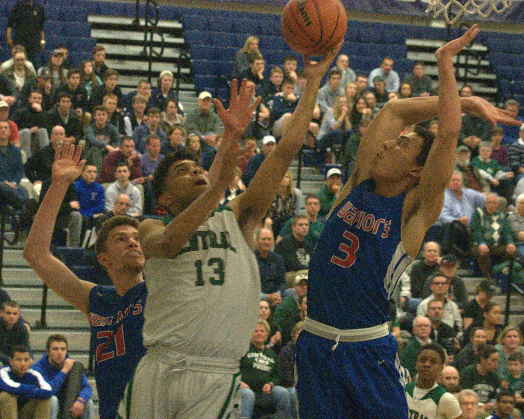 Manchester Central's Jaylen LeRoy puts up a shot as Winnacunnet's Liam Viviano defends.