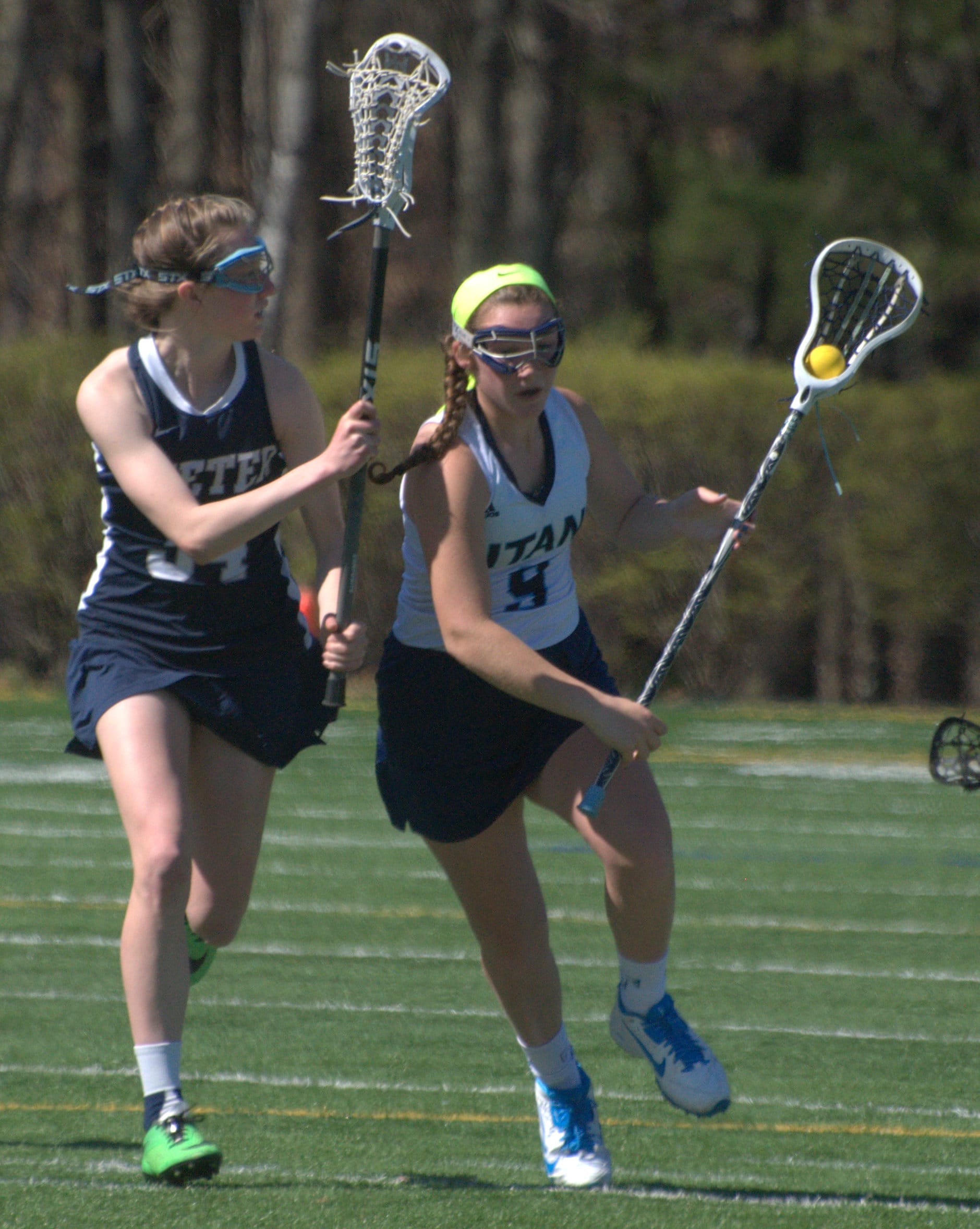 Exeter's Carly Pierce tries to slow down Nashua North's Julia Gagnon.