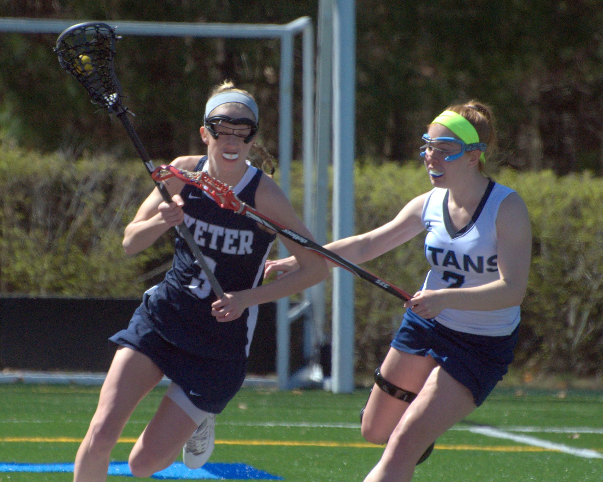 Exeter's Caroline Smith holds the ball as Nashua North's Hannah Fortin gives chase.