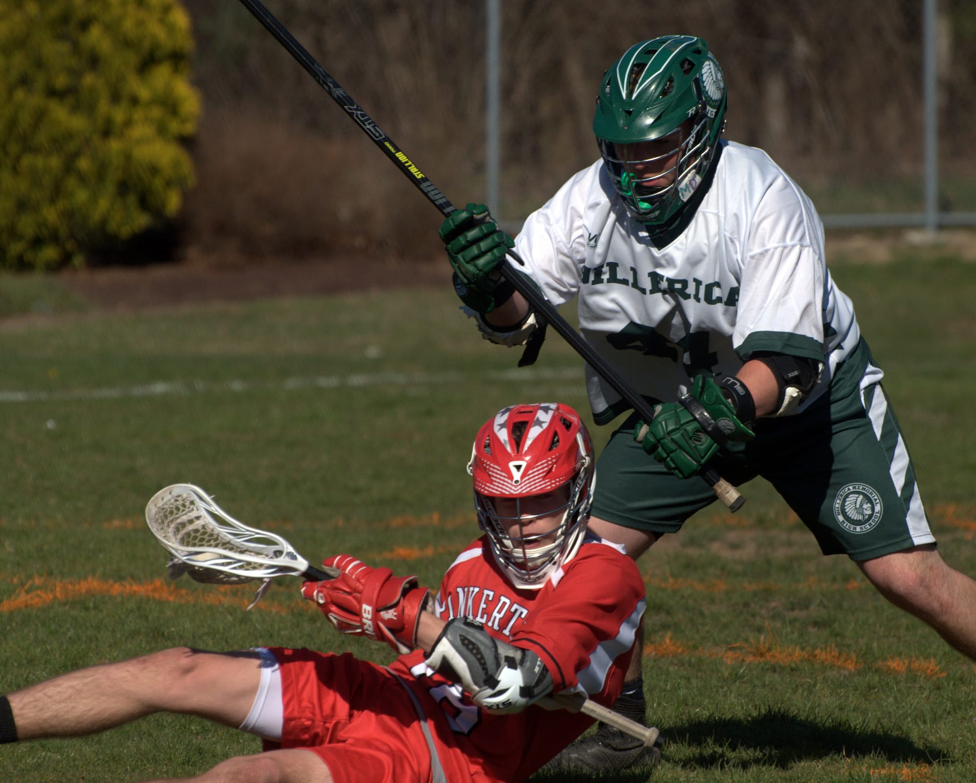 Pinkerton's Ryan Auger hangs on to the ball after getting knocked down by Billerica's Derek Laundry.