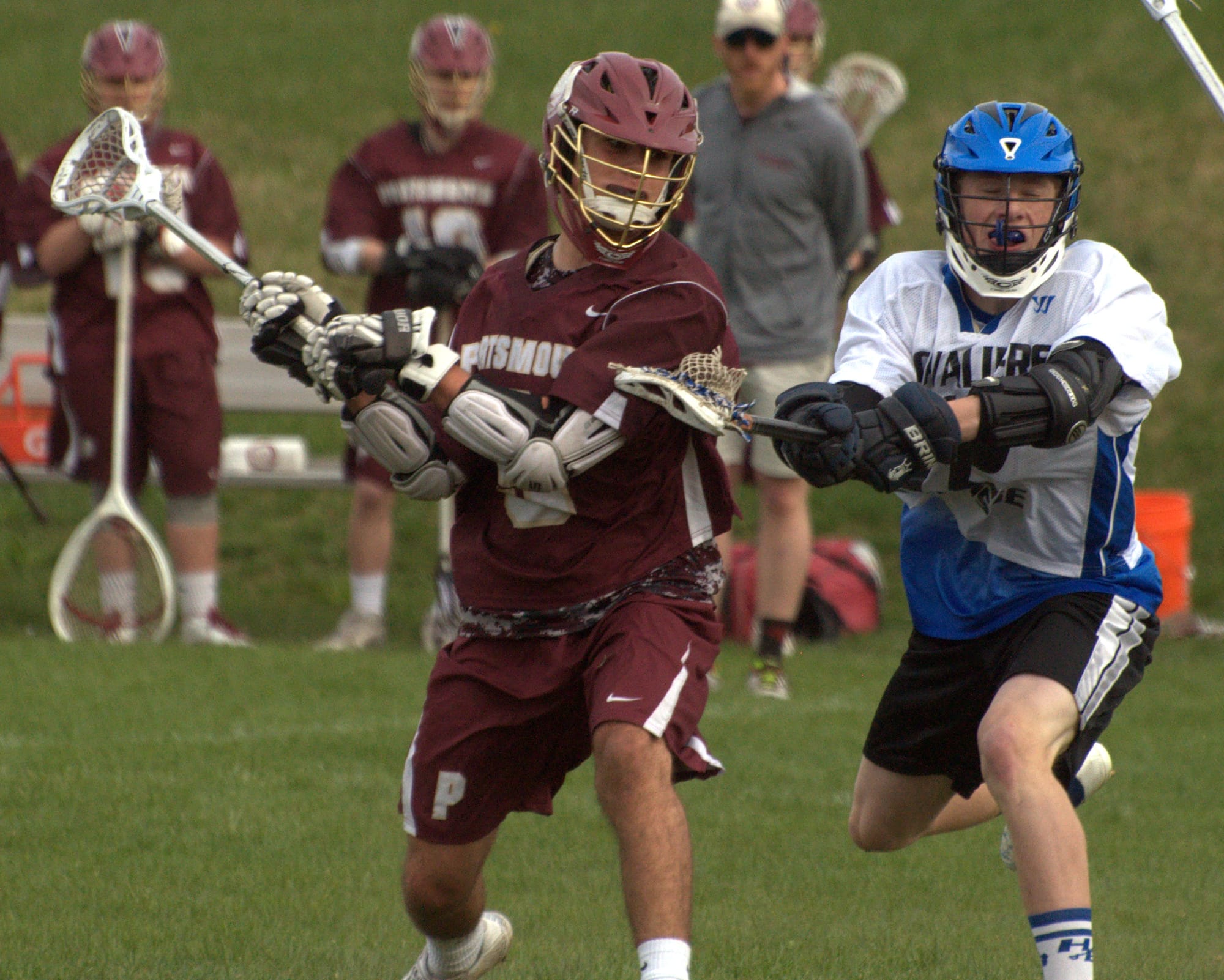 Portsmouth's Zadoc White takes a shot as Hollis Brookline's Nate Hinchliffe defends.