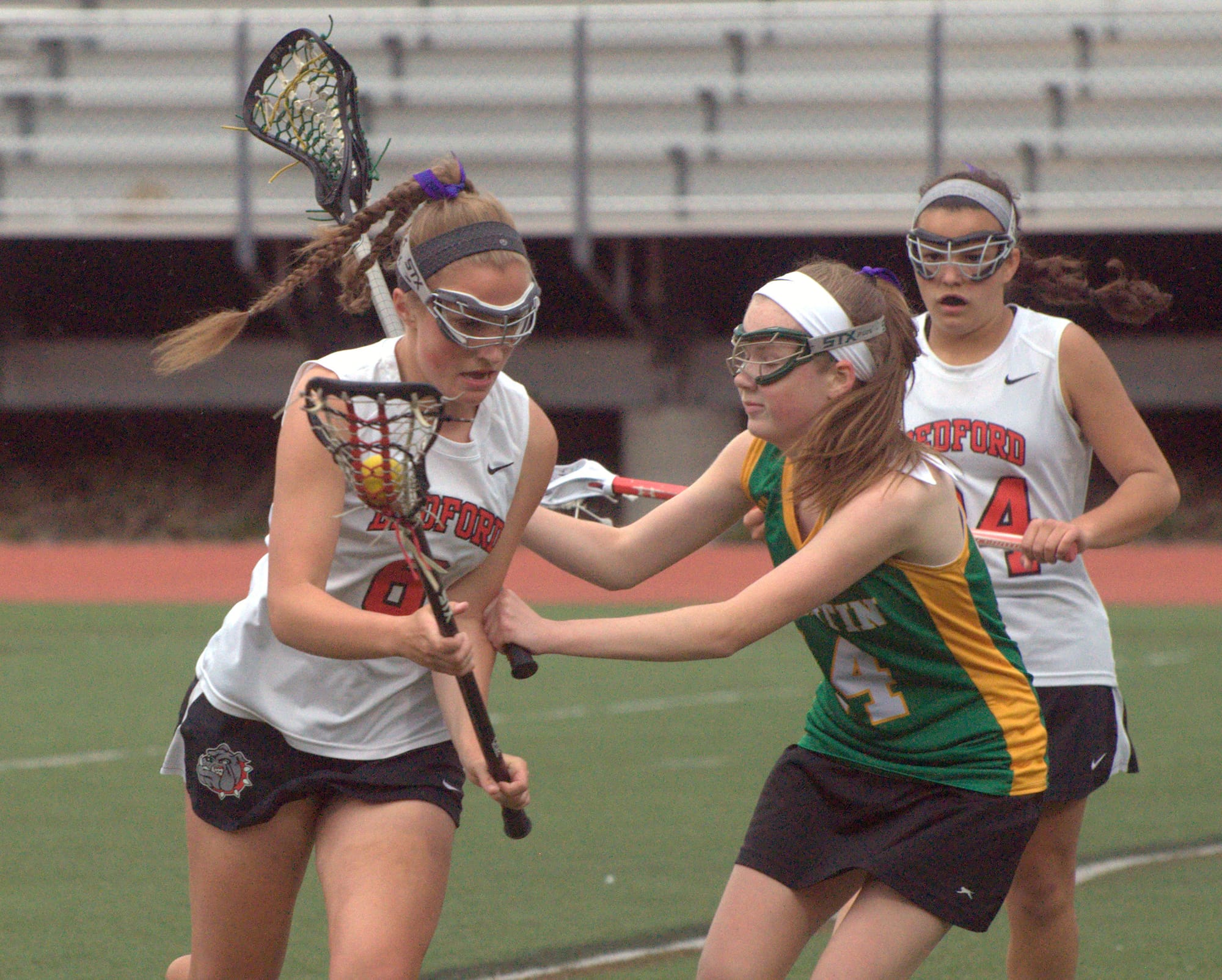 Bedford's Brooke Burdon tries to get by Bishop Guertin's Emily Santom.