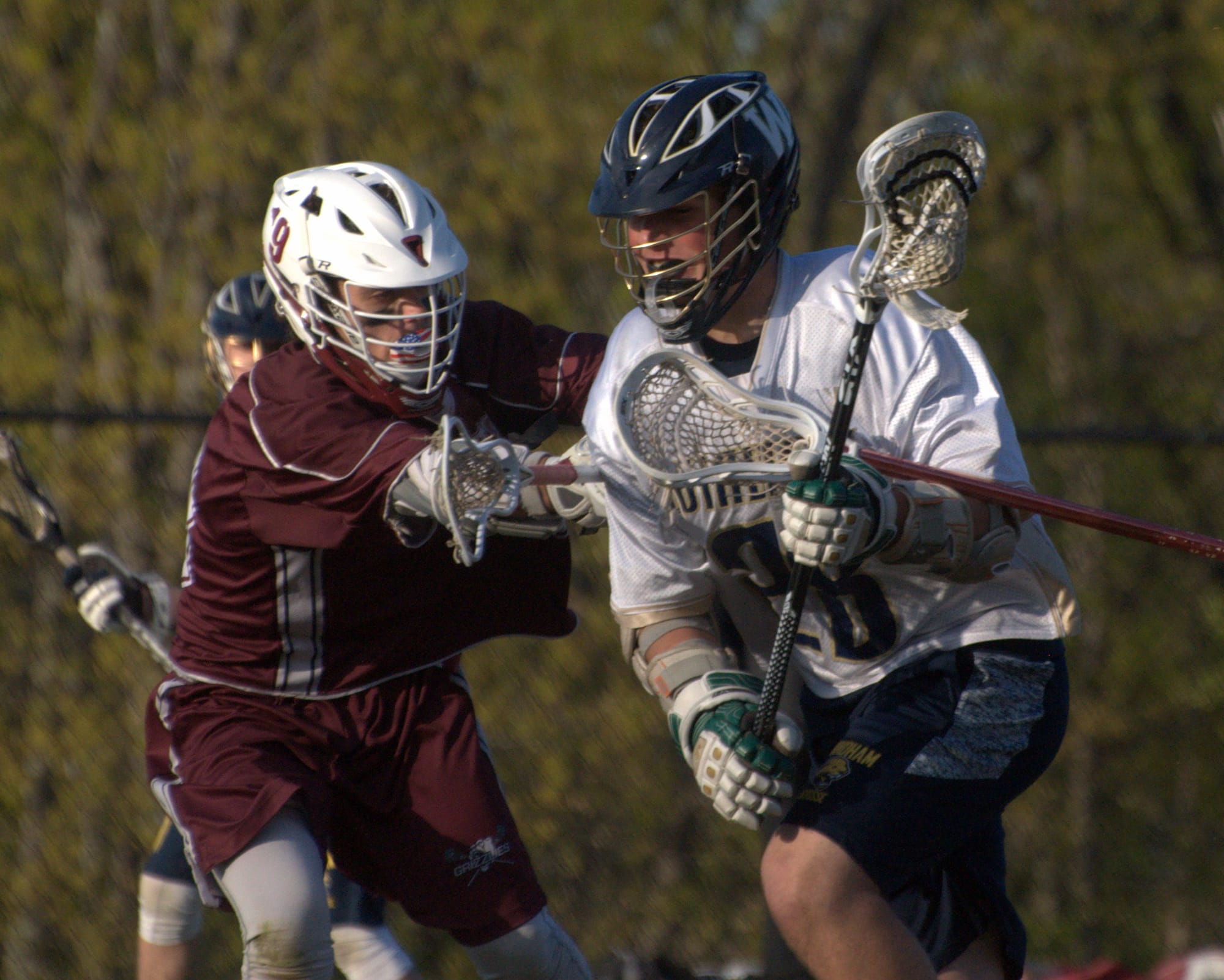 Goffstown's Peyton Bickford tries to slow down Windham's Matt Shea.