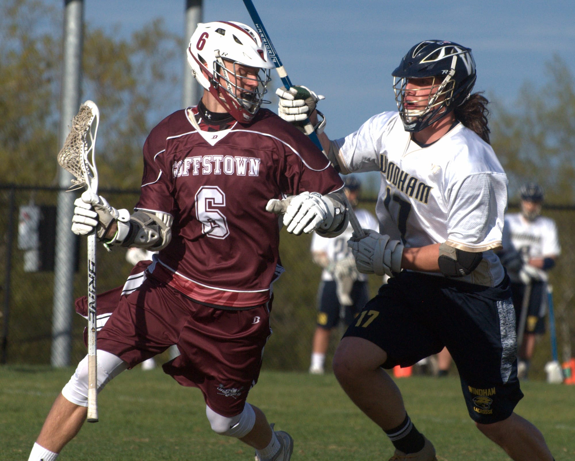 Windham's Steven Bernabei tries to stop Goffstown's Nicholas Ollila.
