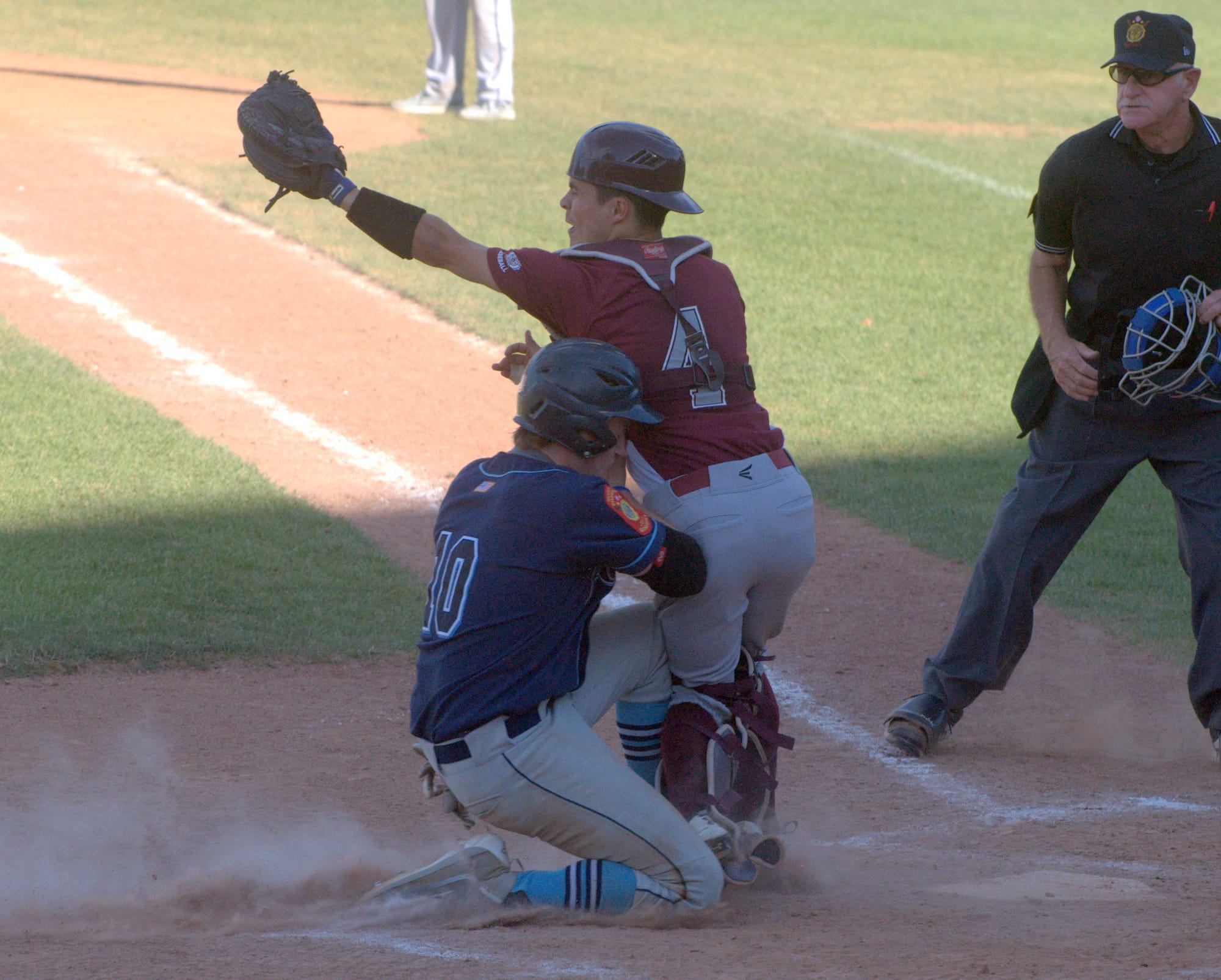 Bedford's Ryan Linehan collides with Merrimack's Ryan Slate as he tries to slide during Sunday's game.