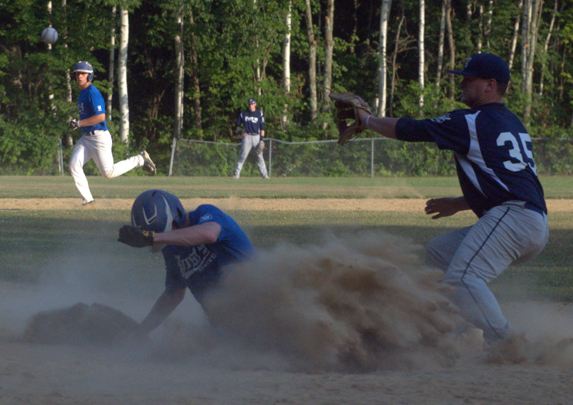 Derry's Ben Curry slides into home before the throw gets to Exeter's Chris Hanna.