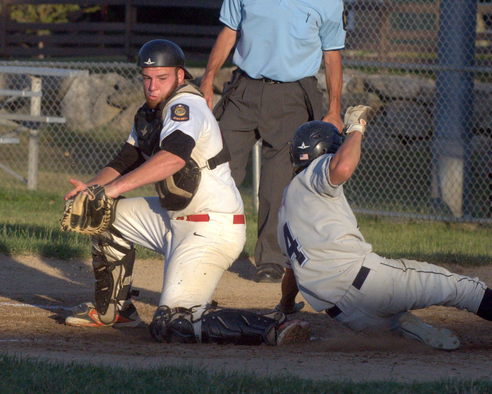 Bedford's Brian Fyfe slides in safely before Milford's CJ Bilodeau can apply the tag.