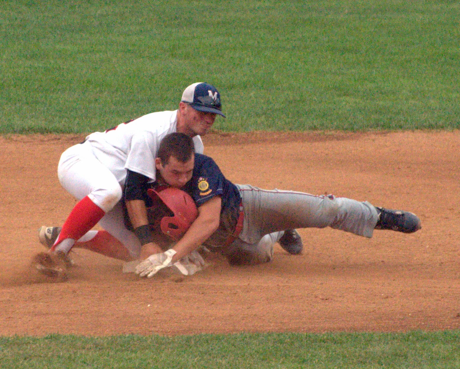 Rochester's Christian Dow loses his helmet after sliding into Milford's Dan Allen.