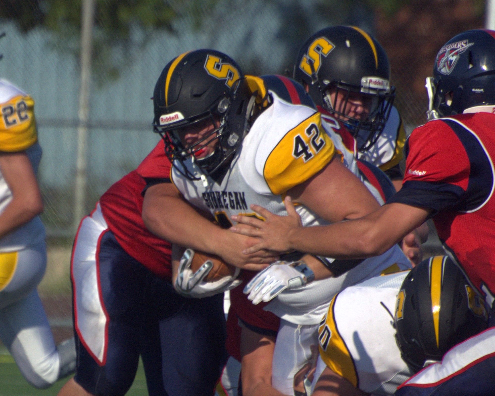 Souhegan's Ben Hart tries to break a tackle against Manchester Memorial.