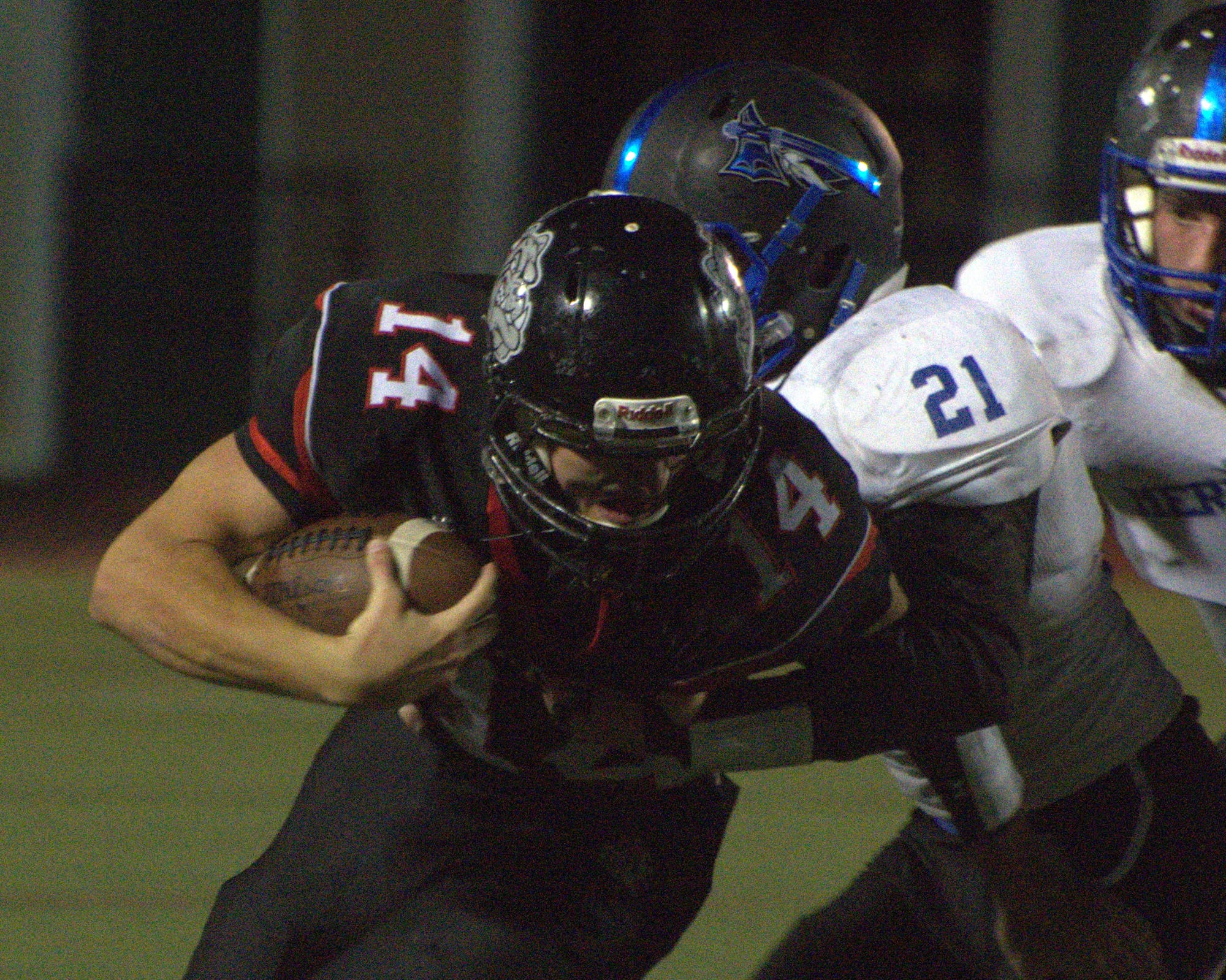 Merrimack's Matthew Goodspeed tries to bring down Bedford's Nick Leahy.