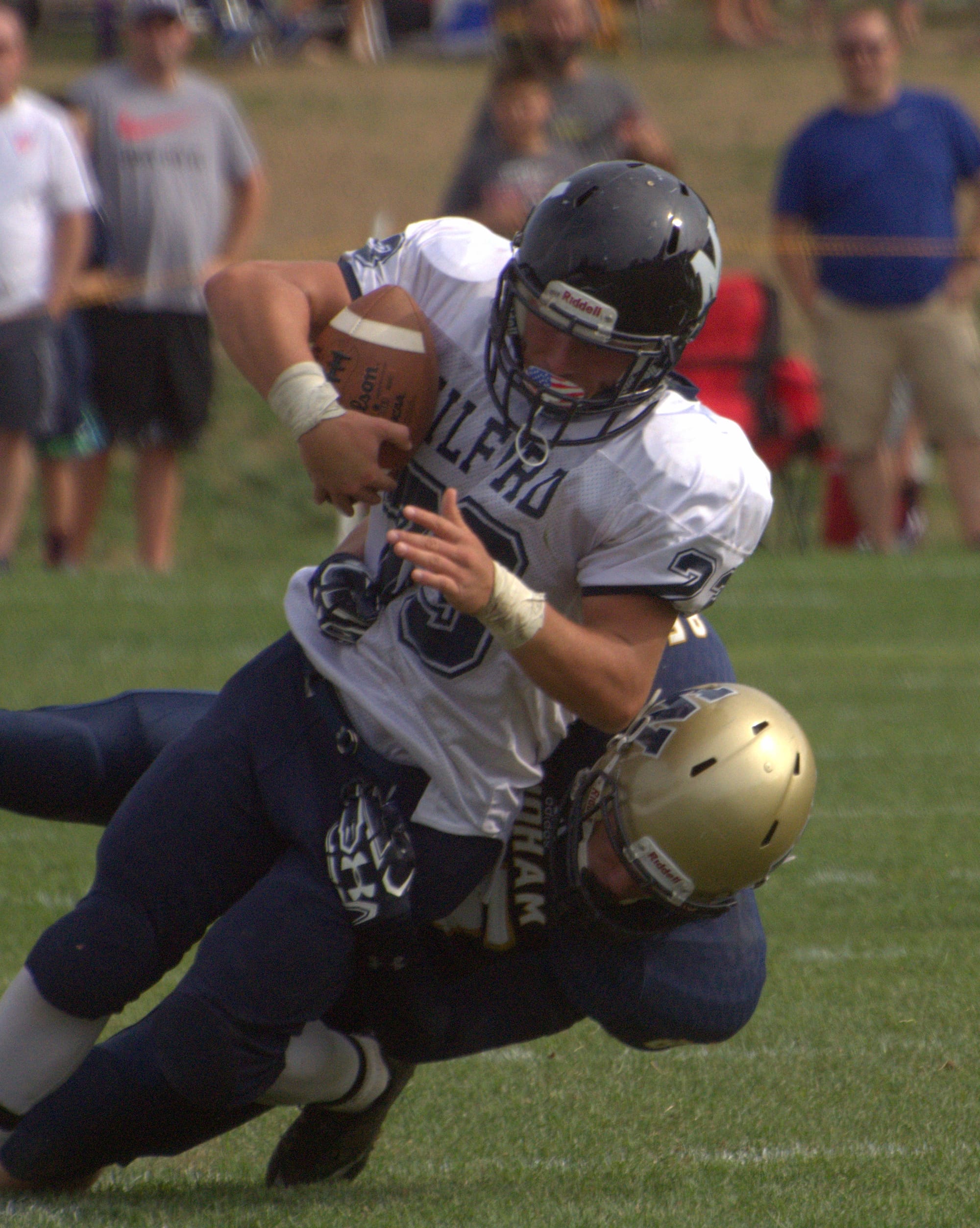 Windham's Jack Connors tackles Milford's Ricky DeBernardo.