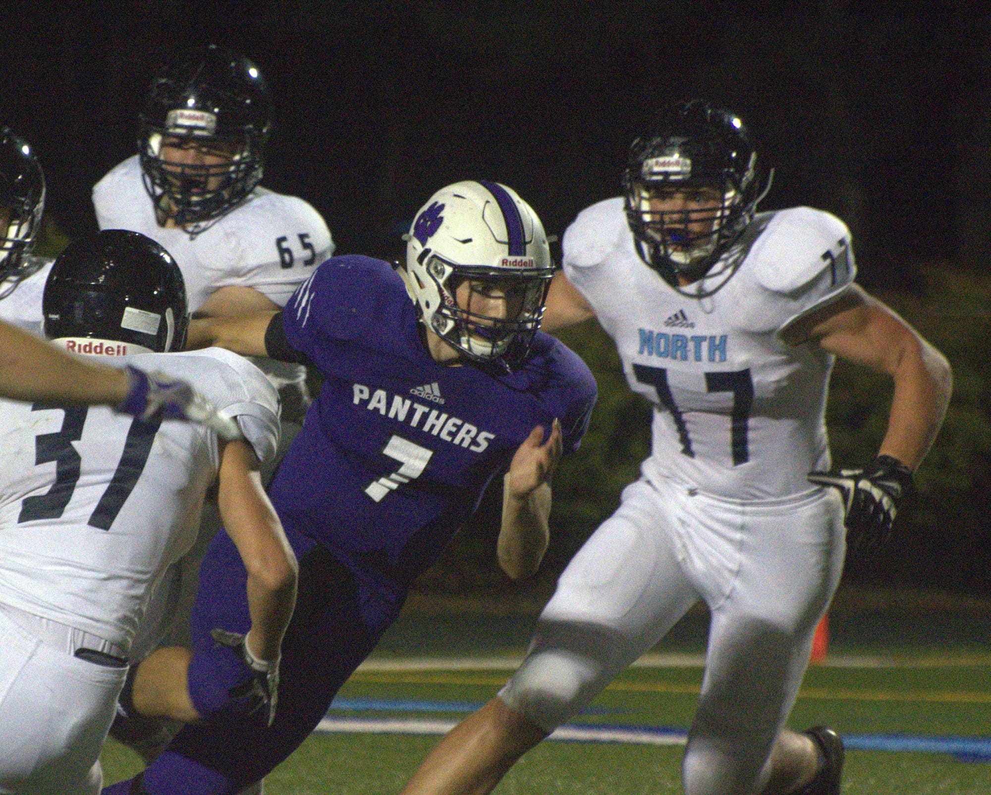 Nashua South's Sean Holland alludes a handful of Nashua North players.