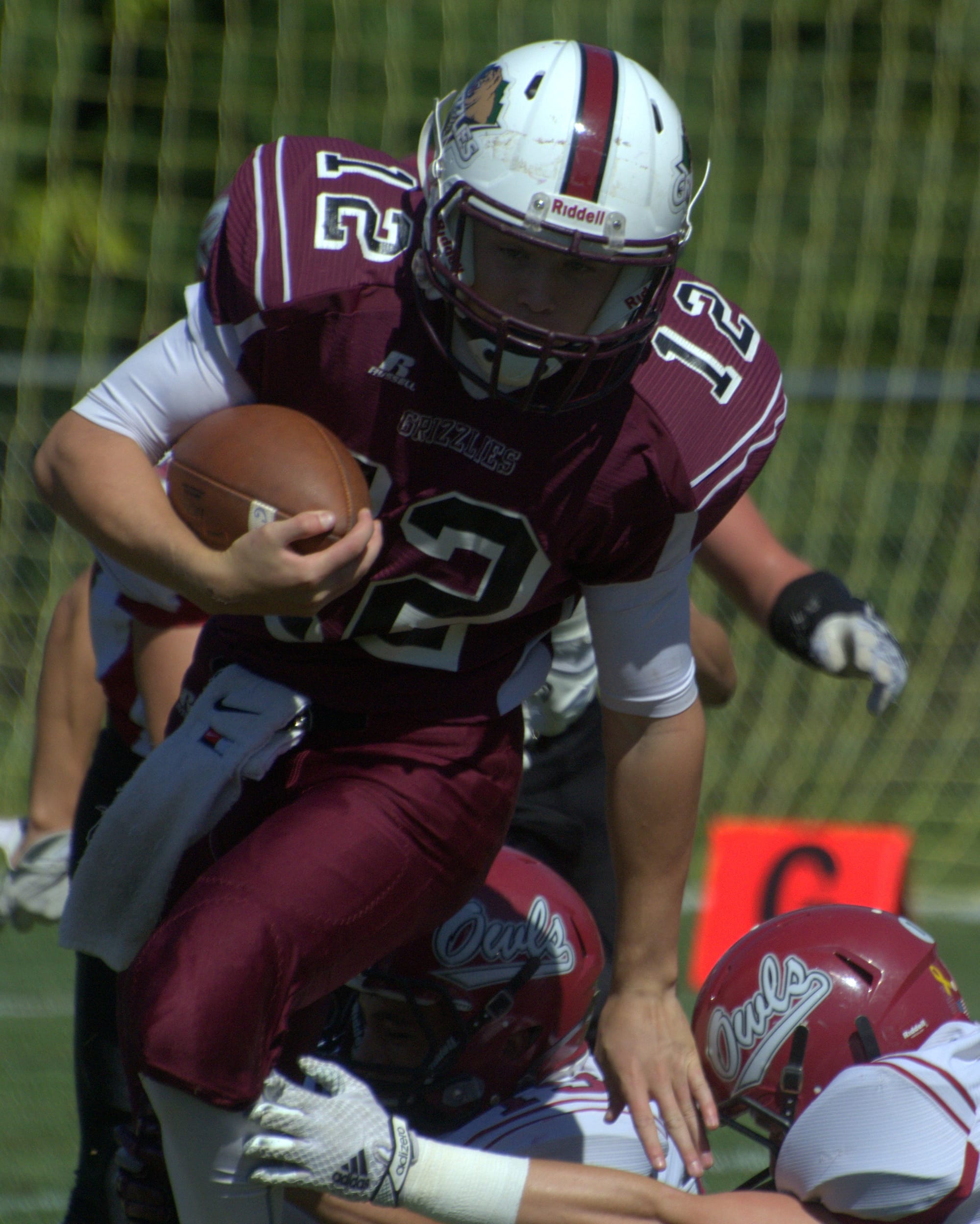 Goffstown's Nik Moquin tries to break a tackle.