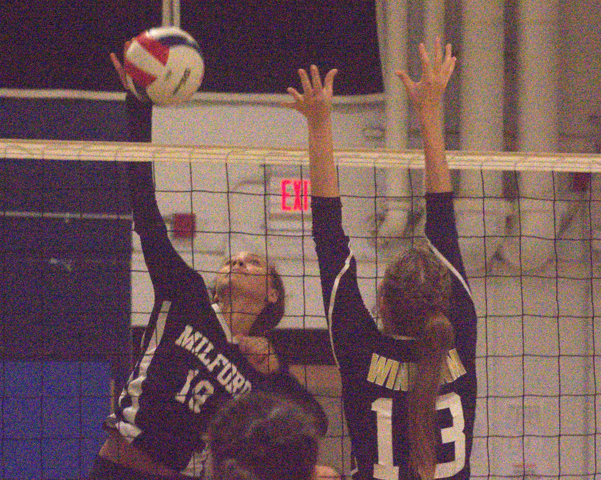 Milford's Gabriella Monico tries to hit the ball past Windham's Emily Frank.