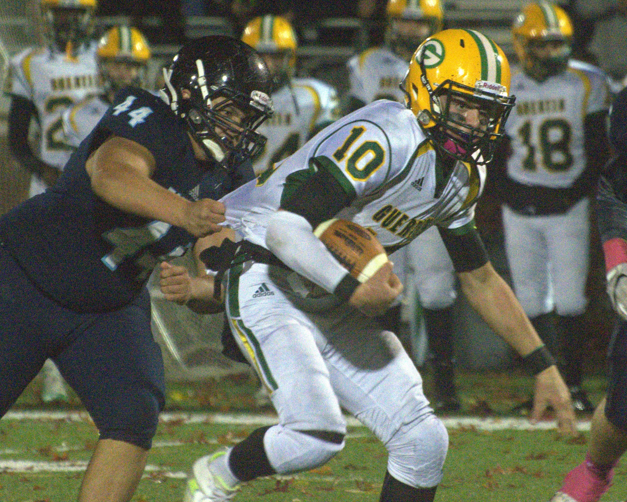 Bishop Guertin's Sam Raitt tries to get away from Nashua North's Kevin Maldanado.