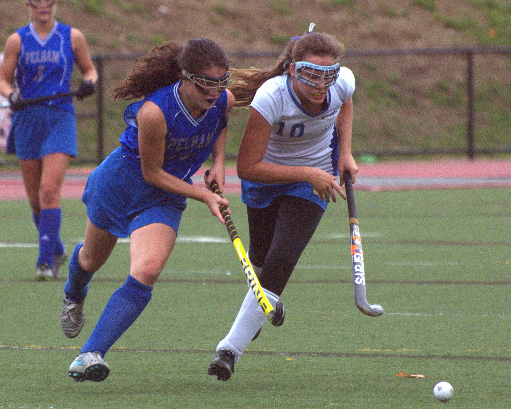 Pelham's Abby Bevens and Gilford's Brianna Salanitro chase after the ball.