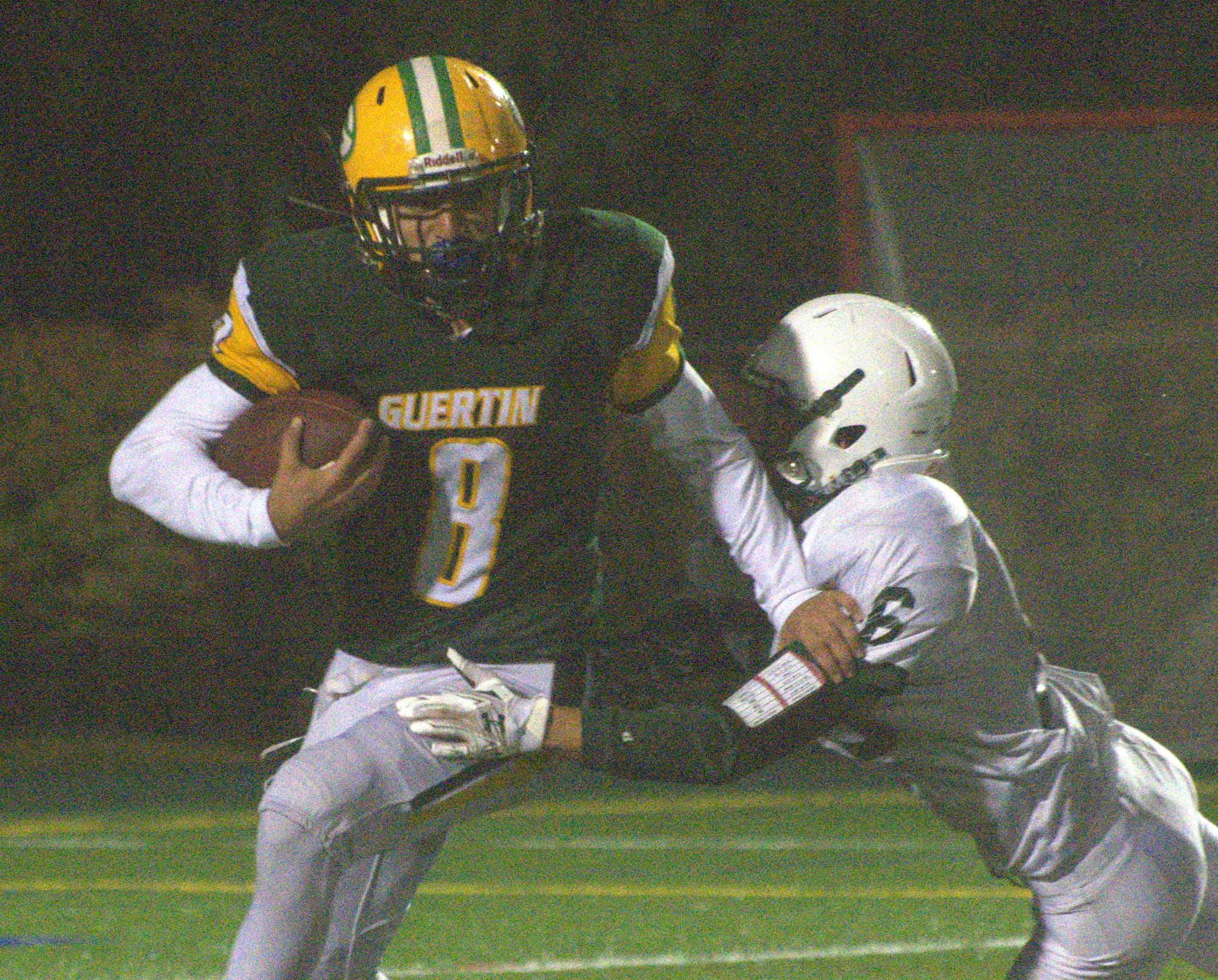 Bishop Guertin's Sarveen Shafian-Rad tries to get away from Dover's Aaron Oroh.