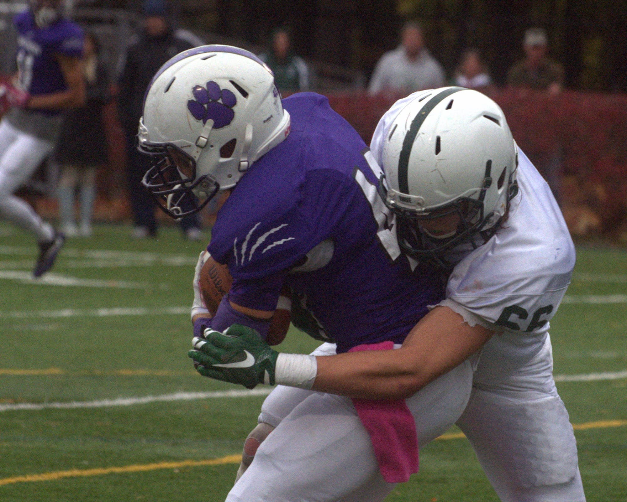 Dover's Dylan Russell wraps up Nashua South's Alex Amigo.